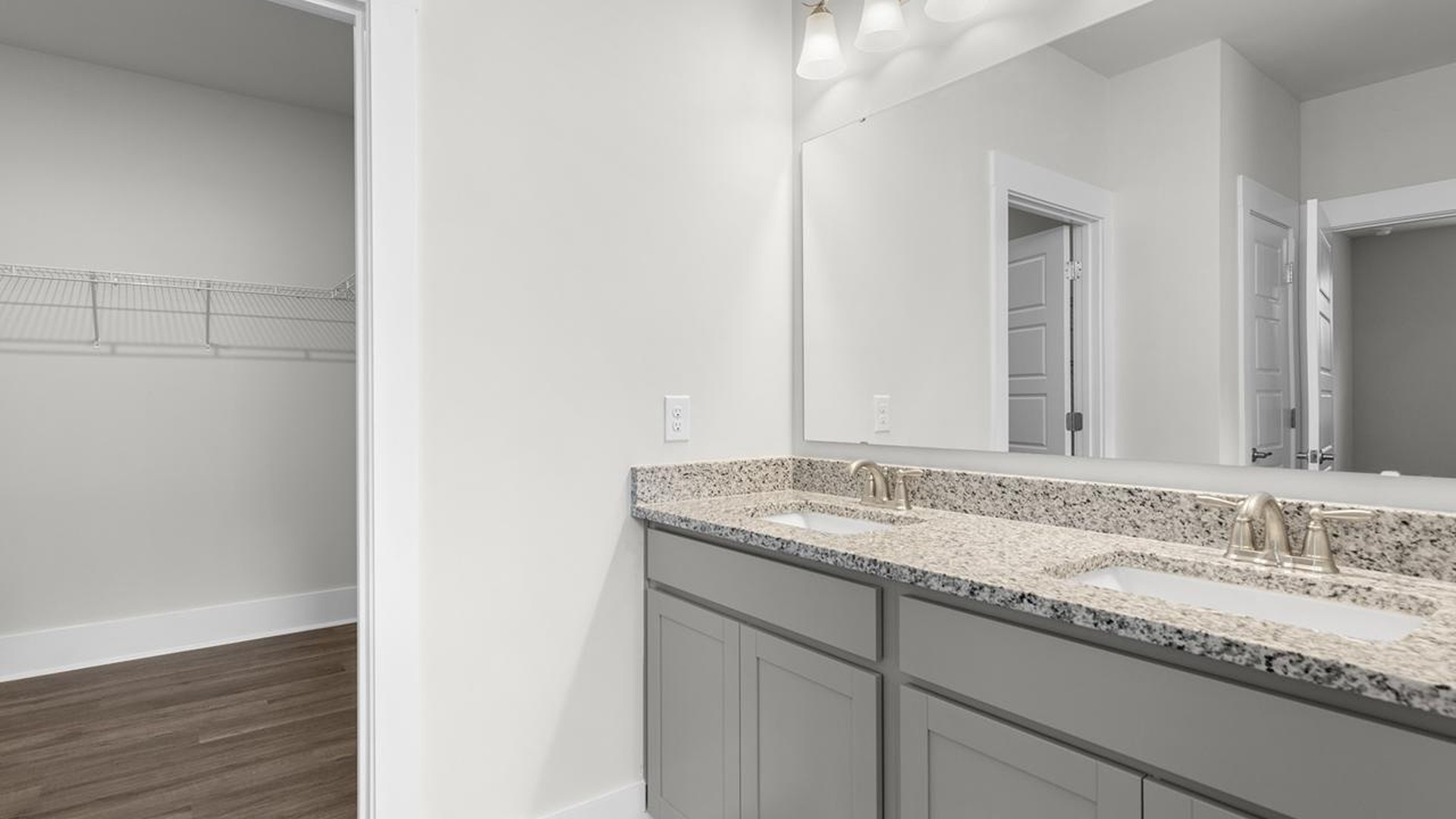 The primary suite serves as a peaceful retreat, featuring an en-suite bathroom with dual vanities and a walk-in closet. The additional bedrooms provide comfort and privacy and share access to a secondary bathroom.