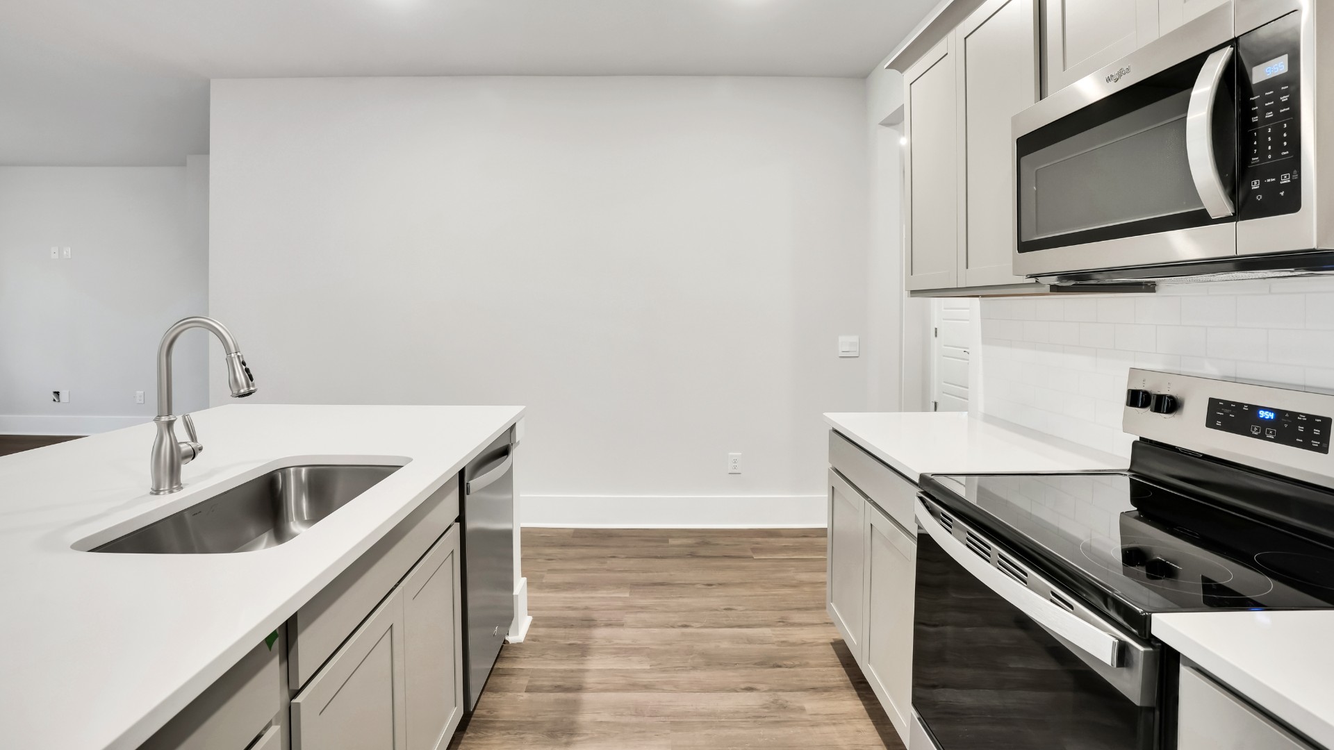 The well-appointed kitchen is equipped with modern appliances, walk-in pantry, and center island, perfect for both cooking and casual dining.