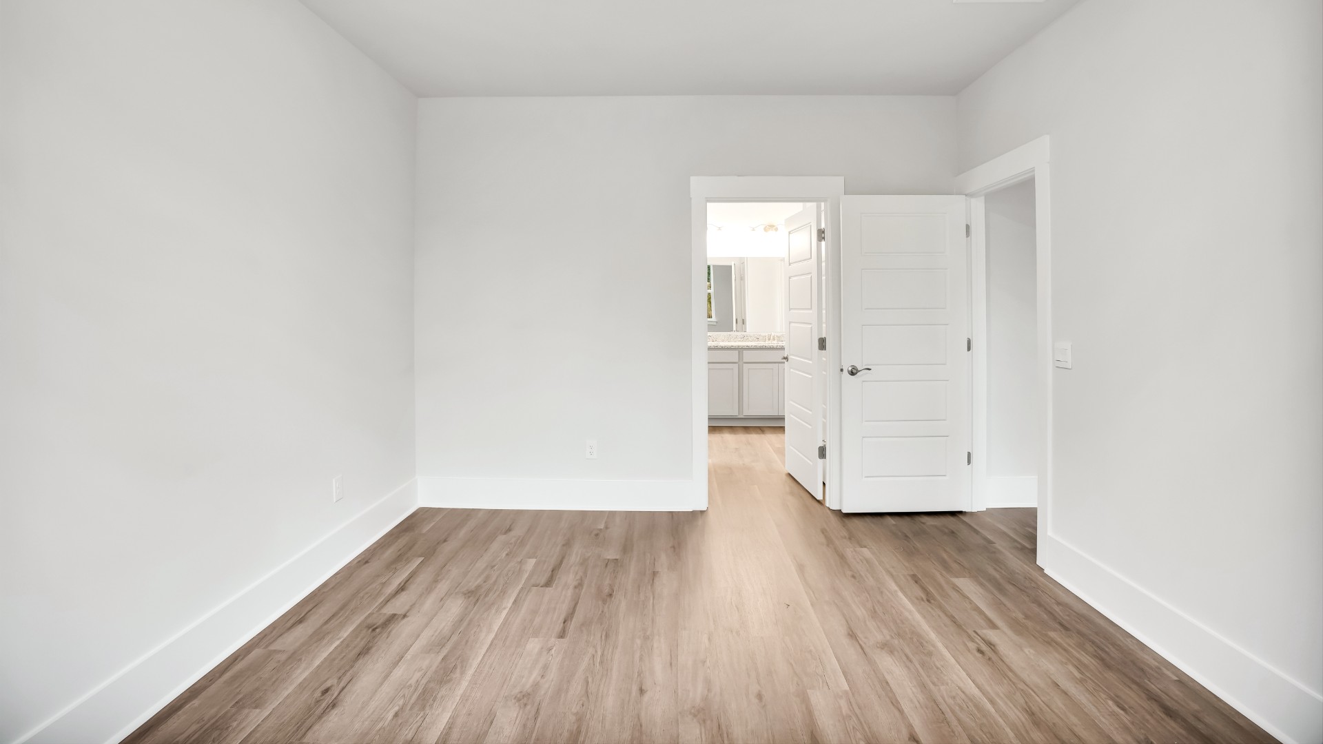 The primary suite serves as a peaceful retreat, featuring an en-suite bathroom with dual vanities and a walk-in closet. T