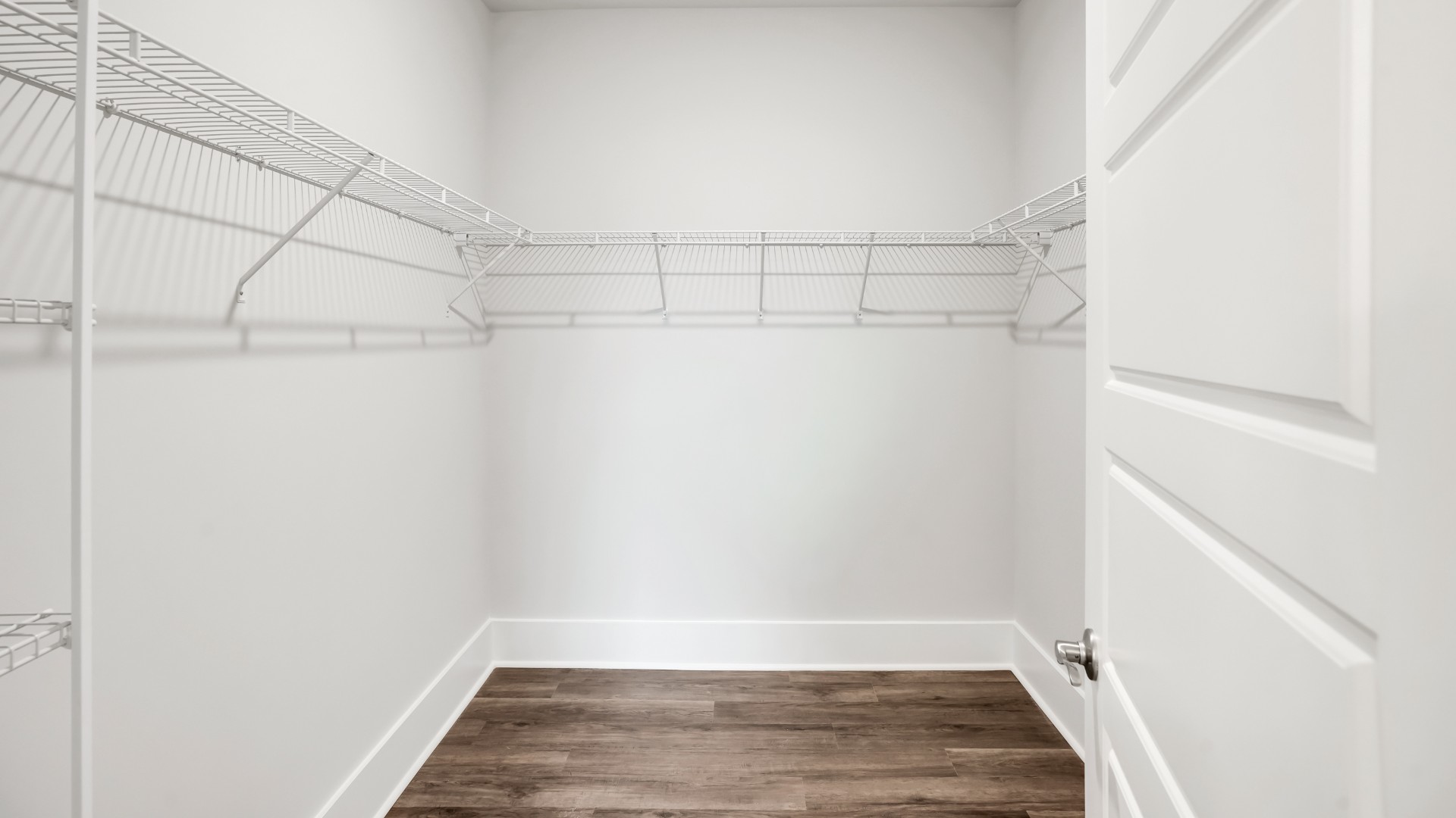 The primary suite serves as a peaceful retreat, featuring an en-suite bathroom with dual vanities and a walk-in closet. T