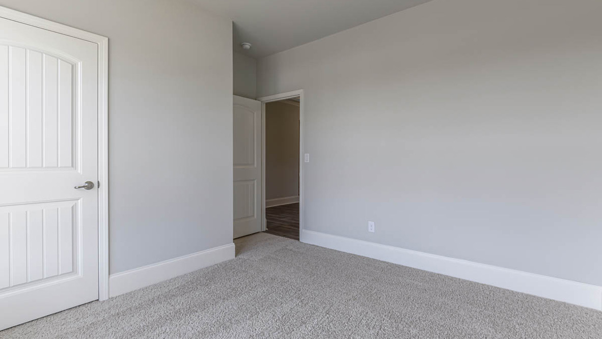 The primary suite serves as a peaceful retreat, featuring an en-suite bathroom with dual vanities and a walk-in closet. The additional bedrooms provide comfort and privacy and share access to a secondary bathroom.