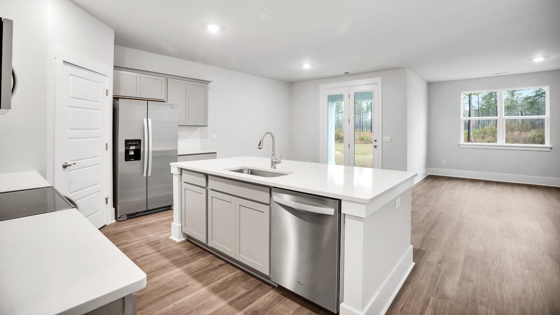 The well-appointed kitchen is equipped with modern appliances, walk-in pantry, and center island, perfect for both cooking and casual dining.