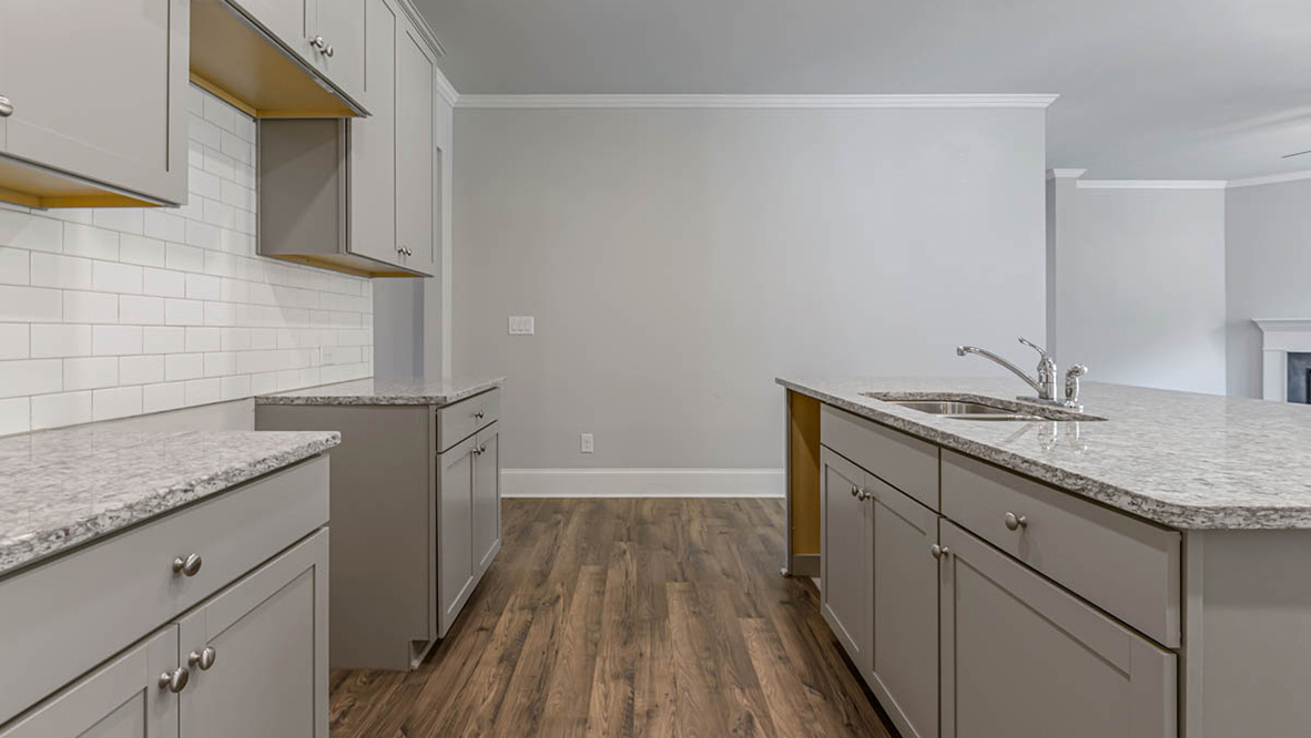 The well-appointed kitchen is equipped with modern appliances, walk-in pantry, and center island, perfect for both cooking and casual dining.