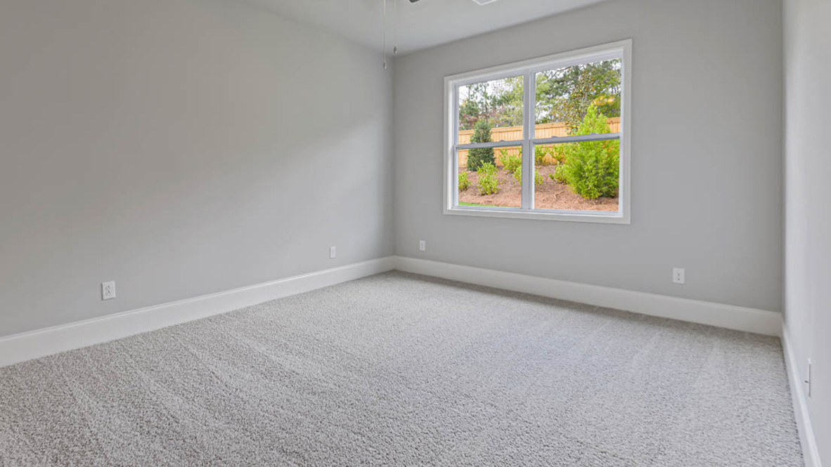 The primary suite serves as a peaceful retreat, featuring an en-suite bathroom with dual vanities and a walk-in closet.