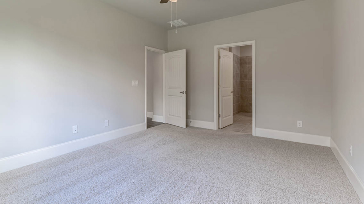 The primary suite serves as a peaceful retreat, featuring an en-suite bathroom with dual vanities and a walk-in closet.