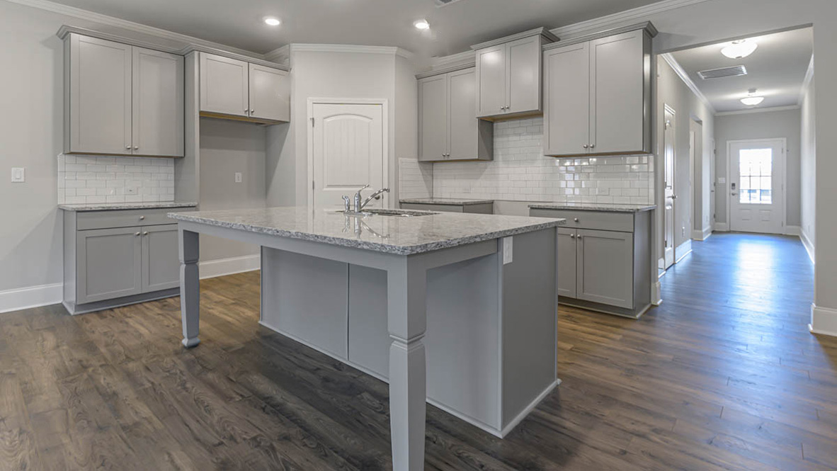 The well-appointed kitchen is equipped with modern appliances, walk-in pantry, and center island, perfect for both cooking and casual dining