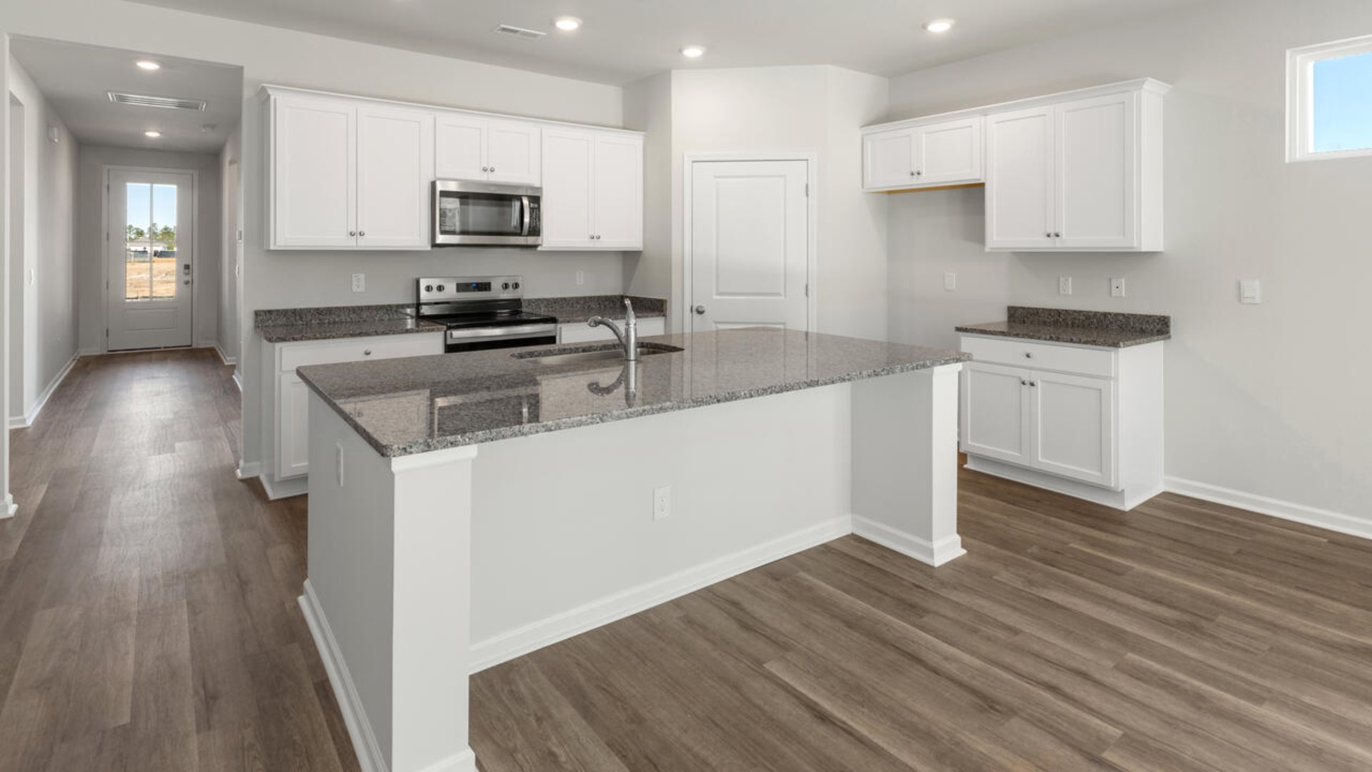 This home boasts granite kitchen counter tops, walk-in pantry, ample storage space a large kitchen island that overlooks the dining area and patio, as well as a 45-degree angle pantry for ample food storage