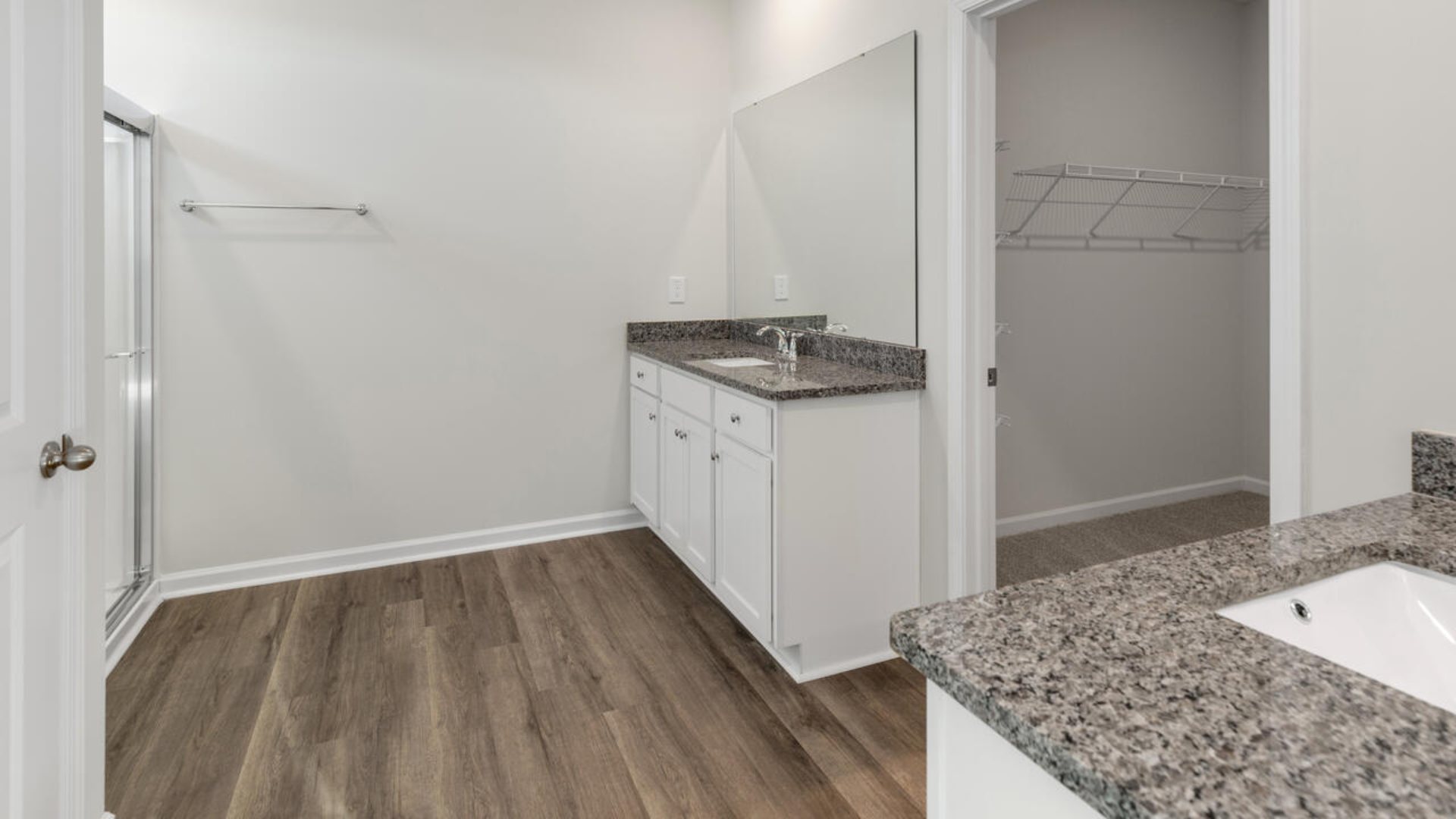 The primary suite as well as on suite is sure to impress with double vanities and a massive walk-in closet., a large, covered porch for those nice breezy sunsets! LVP floors are installed throughout the home as well as the stain resistant carpets that add comfort to the bedrooms.