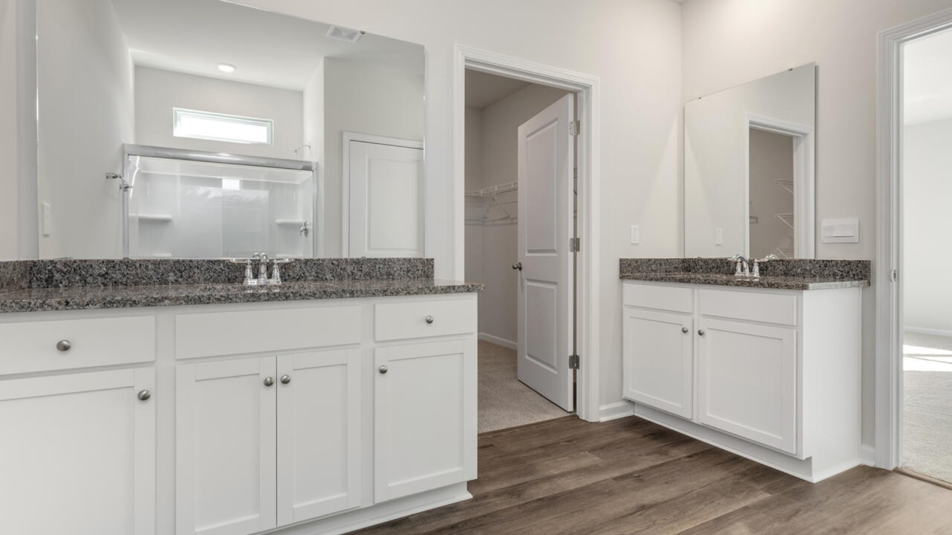 The primary suite as well as on suite is sure to impress with double vanities and a massive walk-in closet., a large, covered porch for those nice breezy sunsets! LVP floors are installed throughout the home as well as the stain resistant carpets that add comfort to the bedrooms.