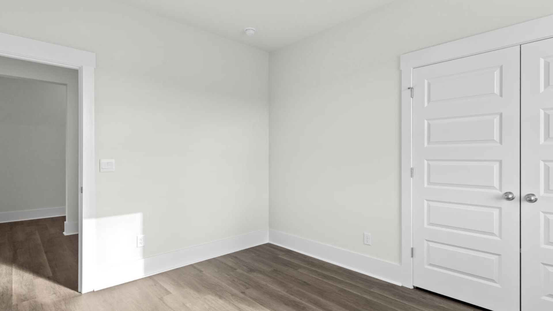 The split bedroom plan creates a private primary bedroom suite featuring two walk-in closets and a spacious en suite bath. There are three bedrooms at the front of the home with a full bathroom as well as laundry room.