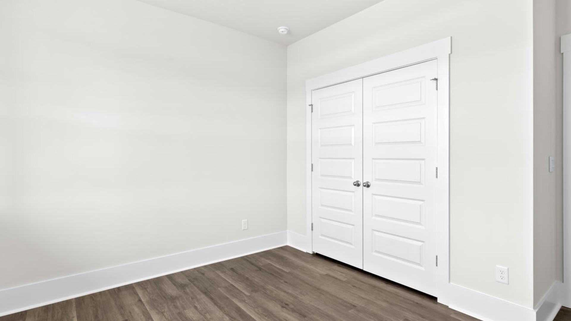 The split bedroom plan creates a private primary bedroom suite featuring two walk-in closets and a spacious en suite bath. There are three bedrooms at the front of the home with a full bathroom as well as laundry room.