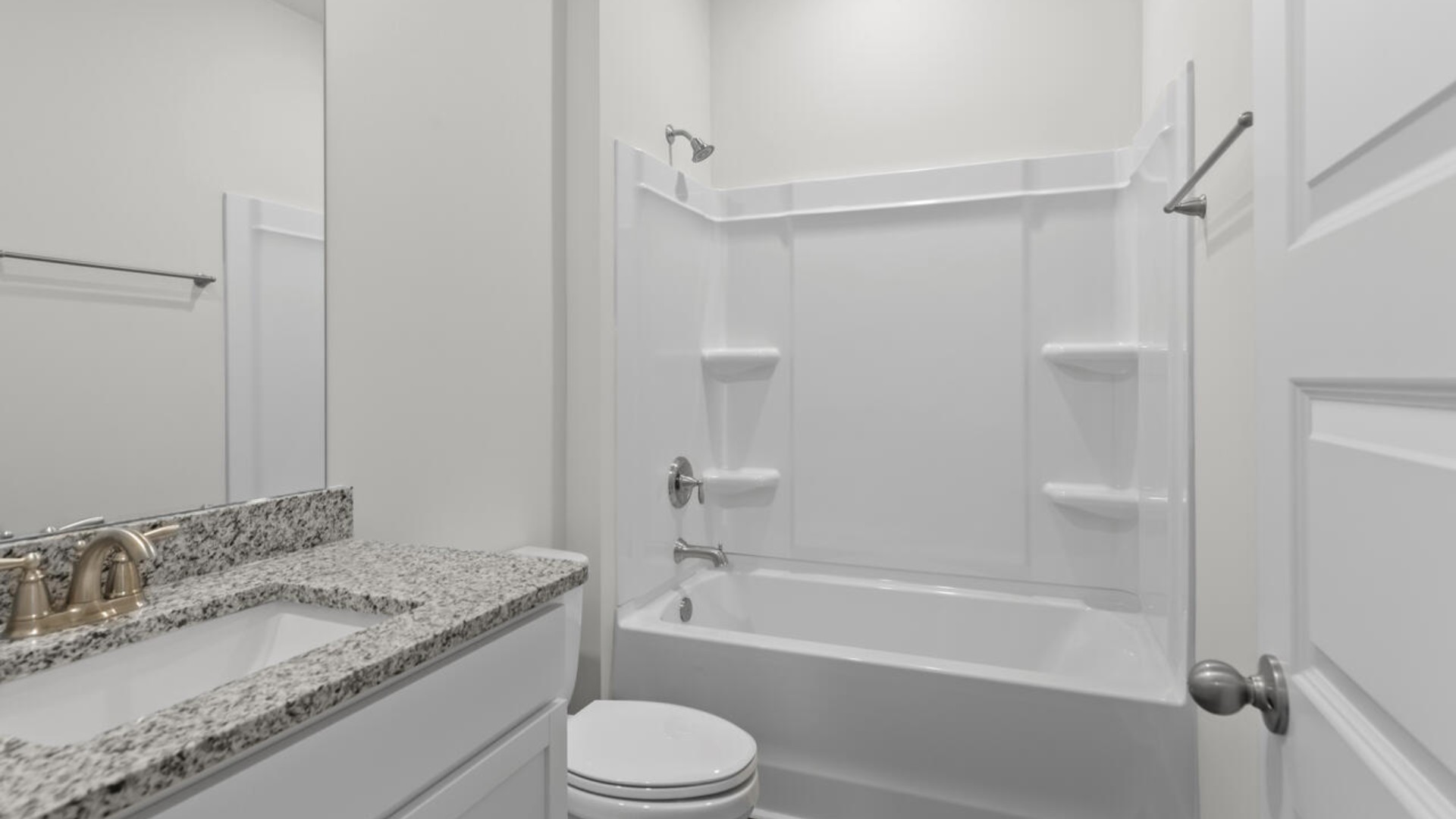 The split bedroom plan creates a private primary bedroom suite featuring two walk-in closets and a spacious en suite bath. There are three bedrooms at the front of the home with a full bathroom as well as laundry room.