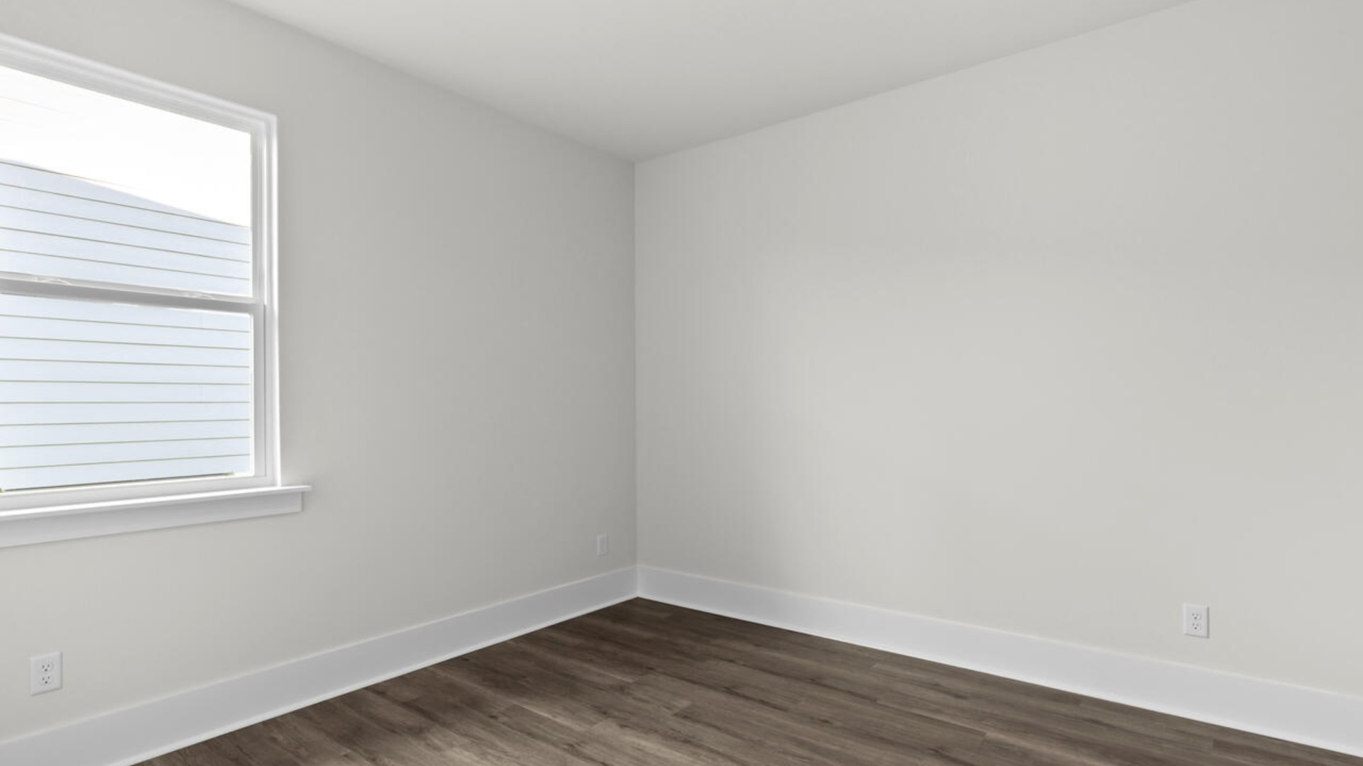 The split bedroom plan creates a private primary bedroom suite featuring two walk-in closets and a spacious en suite bath. There are three bedrooms at the front of the home with a full bathroom as well as laundry room.