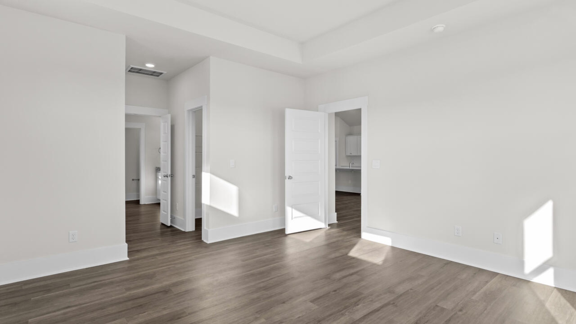 The split bedroom plan creates a private primary bedroom suite featuring two walk-in closets and a spacious en suite bath. There are three bedrooms at the front of the home with a full bathroom as well as laundry room.