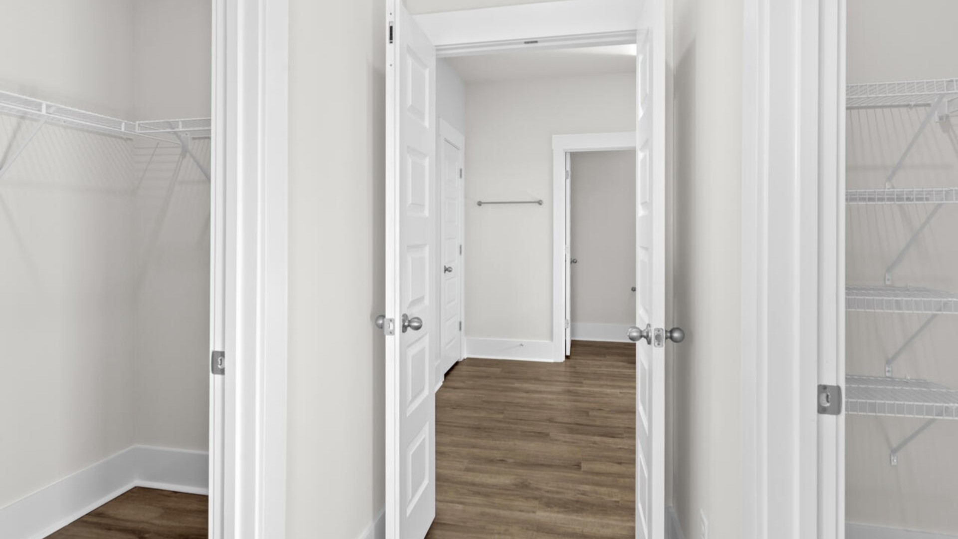 The split bedroom plan creates a private primary bedroom suite featuring two walk-in closets and a spacious en suite bath. There are three bedrooms at the front of the home with a full bathroom as well as laundry room.