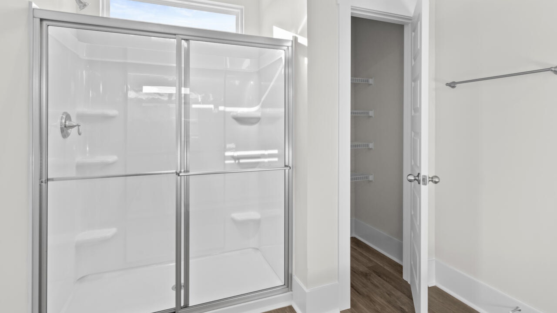 The split bedroom plan creates a private primary bedroom suite featuring two walk-in closets and a spacious en suite bath. There are three bedrooms at the front of the home with a full bathroom as well as laundry room.