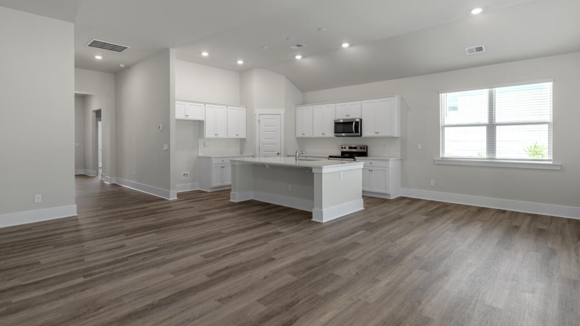Open concept design with plenty of room for everyone to gather around the huge kitchen island.