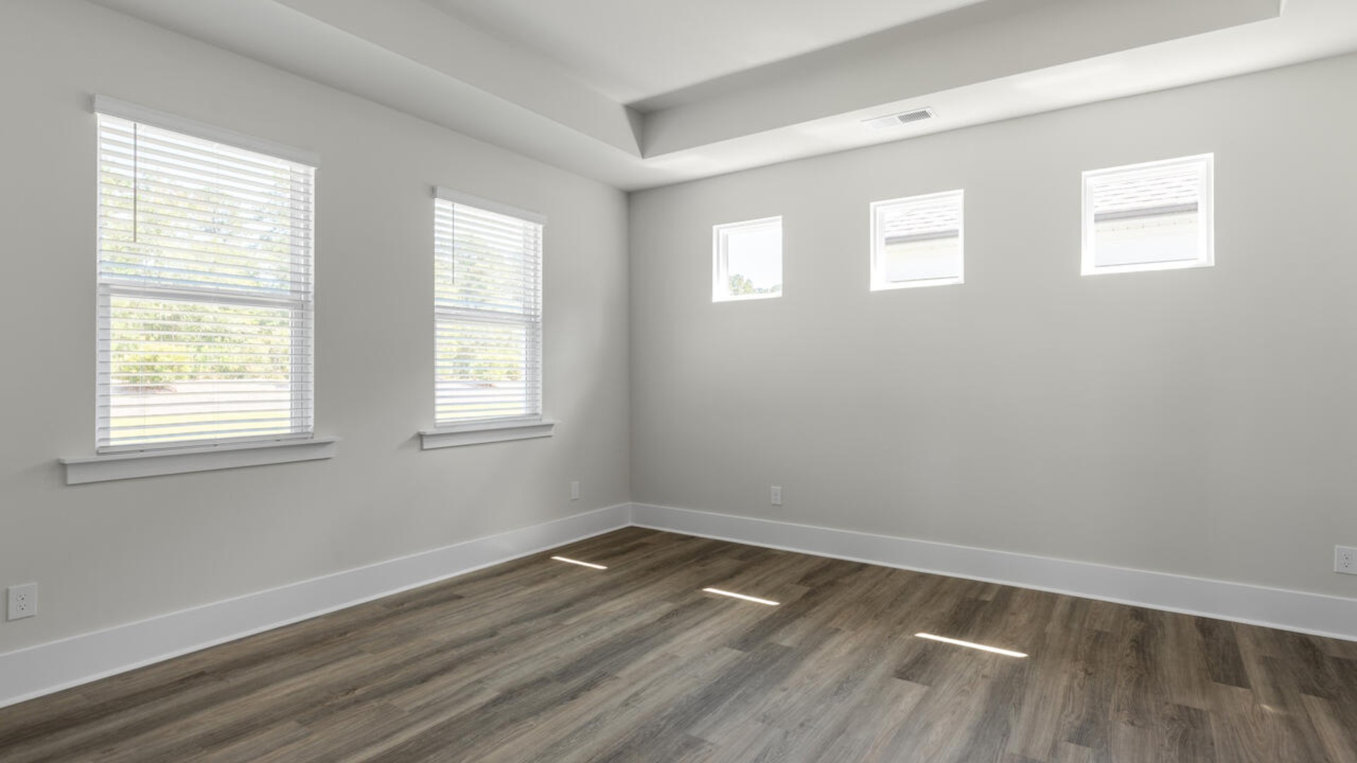 The split bedroom plan creates a private primary bedroom suite featuring two walk-in closets and a spacious en suite bath.