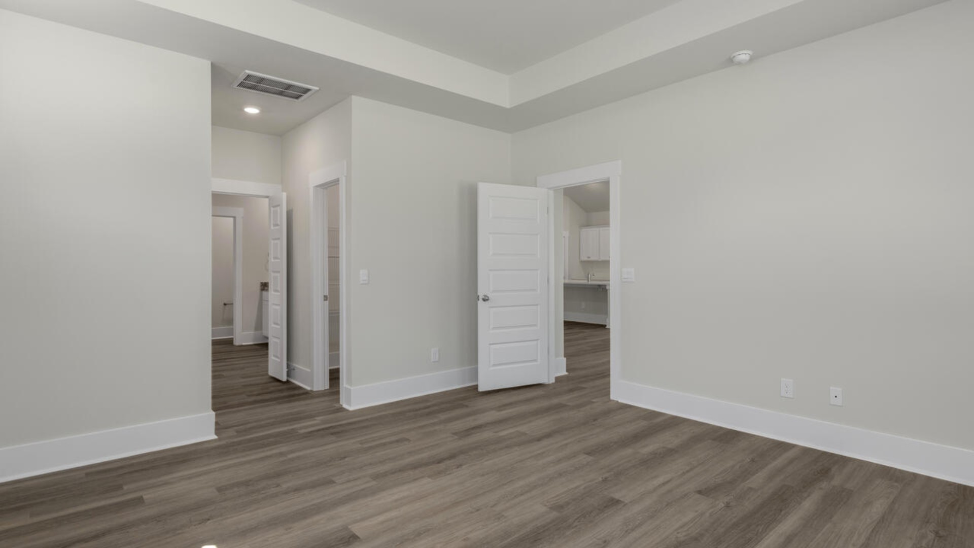 The split bedroom plan creates a private primary bedroom suite featuring two walk-in closets and a spacious en suite bath.