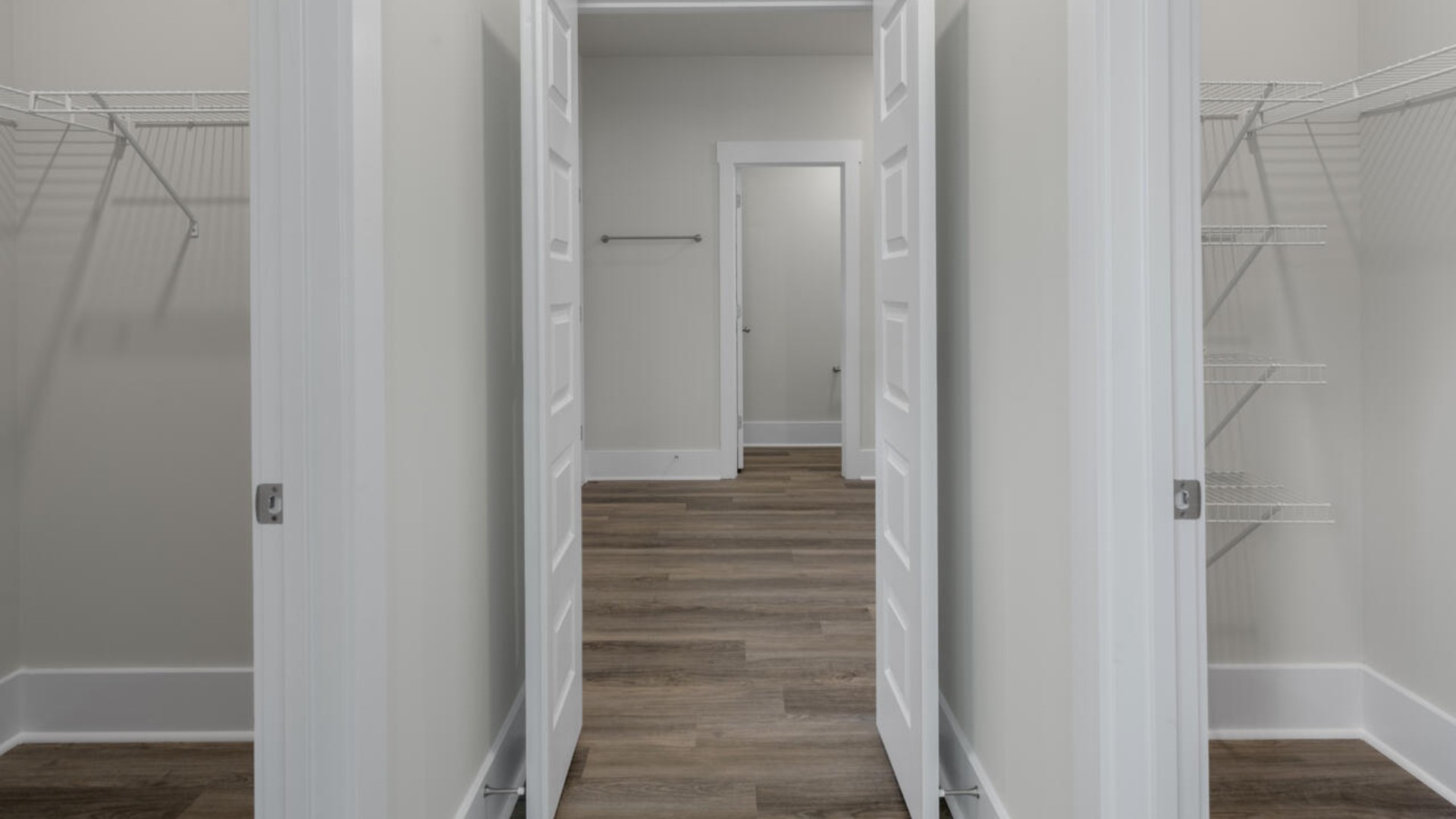 The split bedroom plan creates a private primary bedroom suite featuring two walk-in closets and a spacious en suite bath.