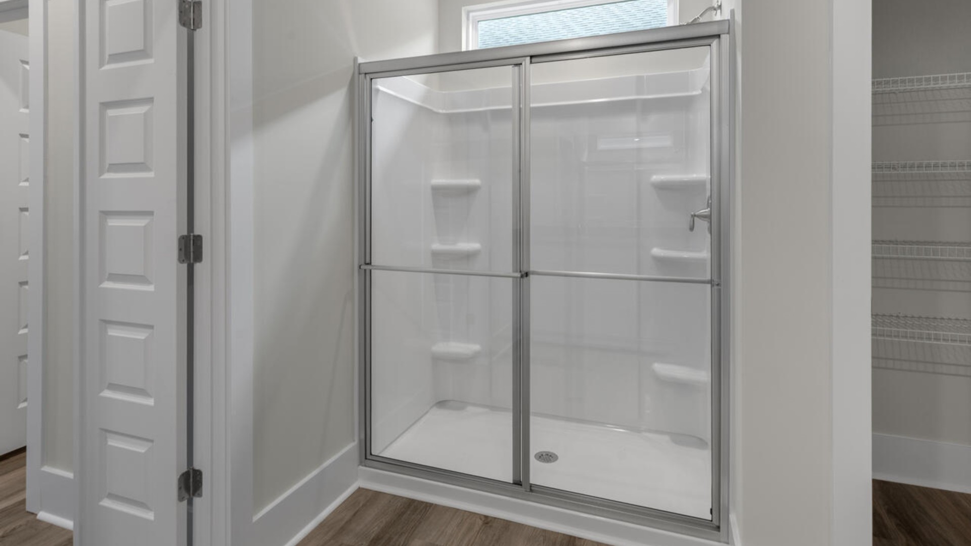 The split bedroom plan creates a private primary bedroom suite featuring two walk-in closets and a spacious en suite bath.