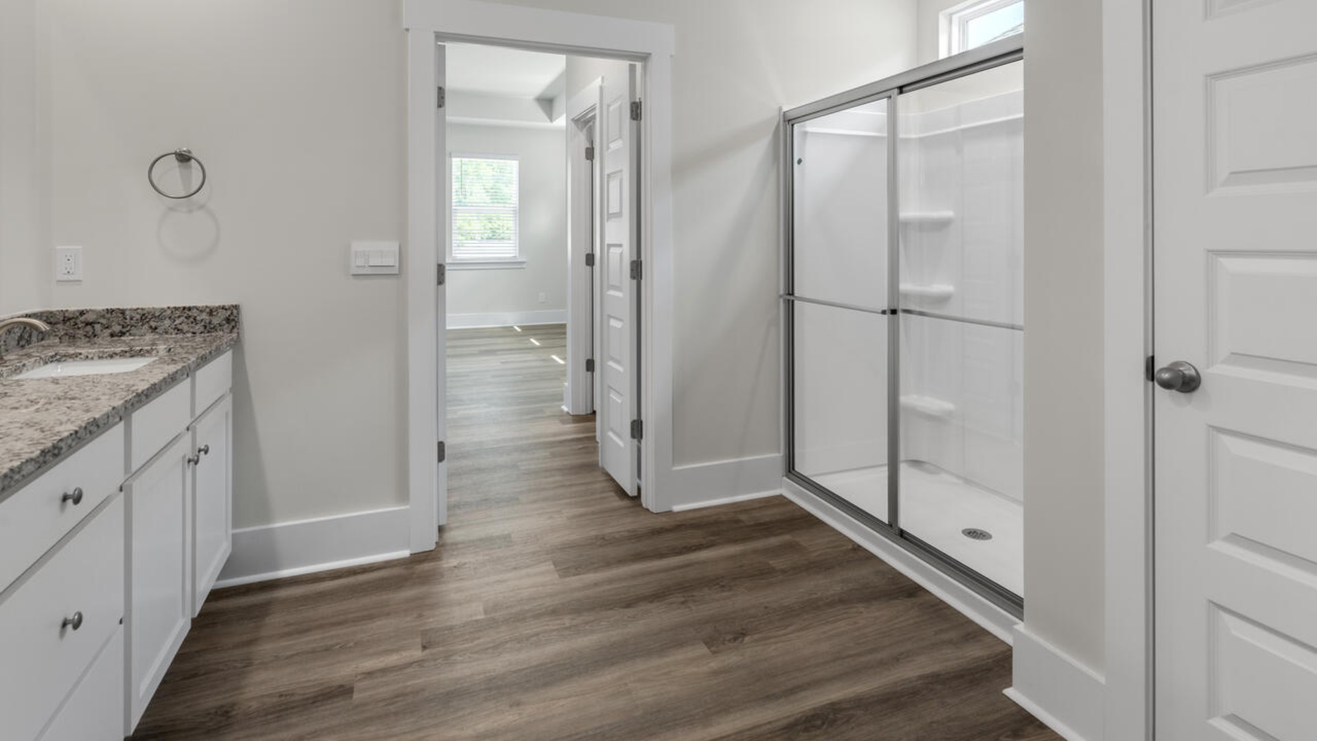 The split bedroom plan creates a private primary bedroom suite featuring two walk-in closets and a spacious en suite bath.