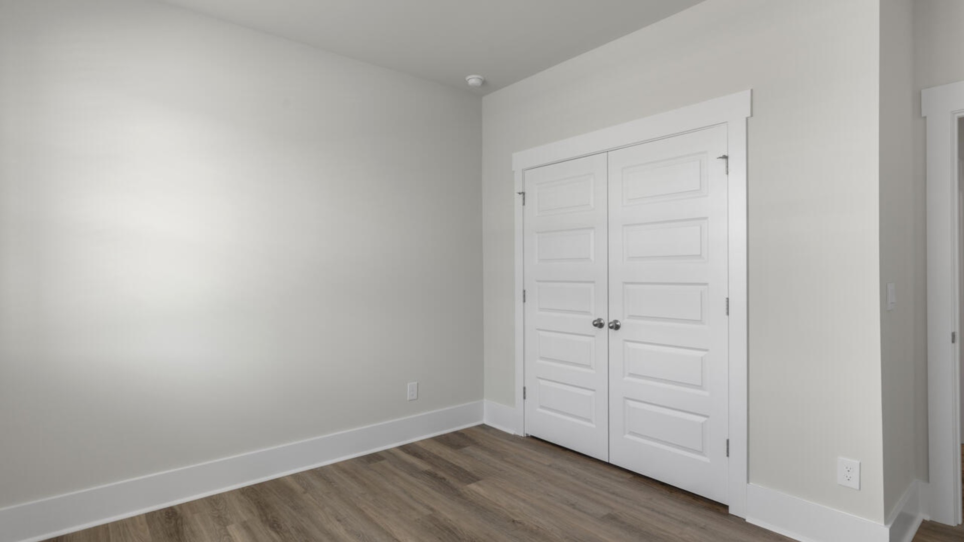 The split bedroom plan creates a private primary bedroom suite featuring two walk-in closets and a spacious en suite bath. There are three bedrooms at the front of the home with a full bathroom as well as laundry room.