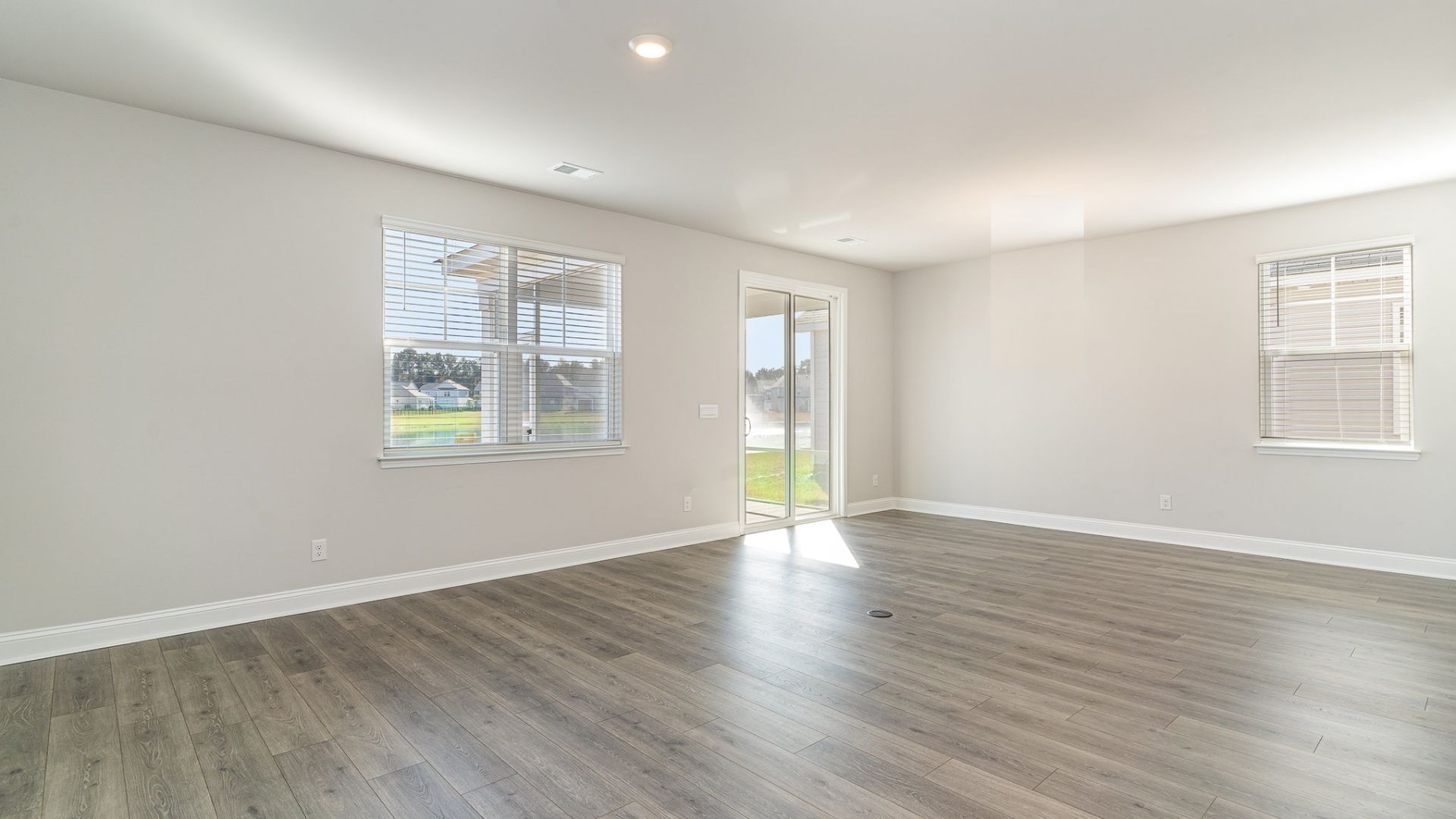 The kitchen features shaker-style cabinets, quartz countertops, and stainless steel appliances, which are sure to both turn heads and make meal prep easy. You’ll never be too far from the action with the living and dining area right there.