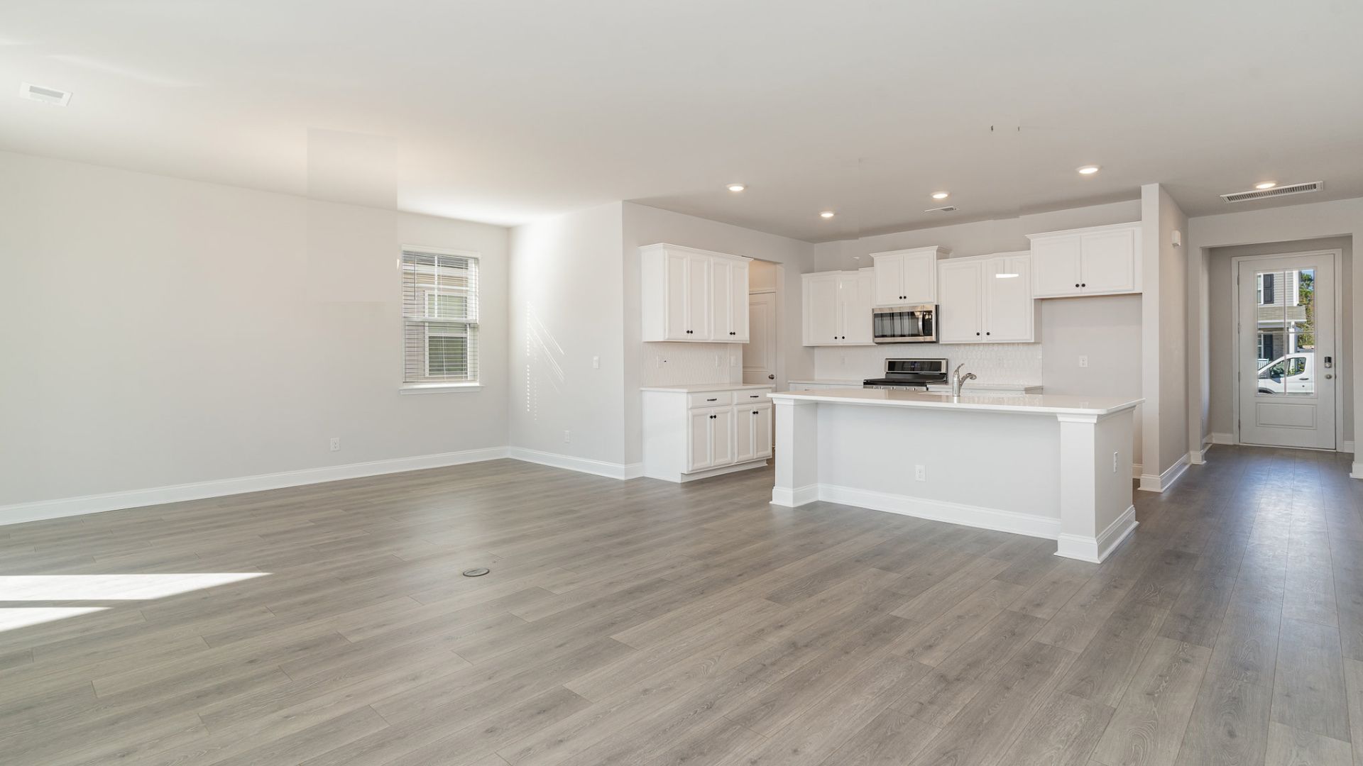 The kitchen features shaker-style cabinets, quartz countertops, and stainless steel appliances, which are sure to both turn heads and make meal prep easy. You’ll never be too far from the action with the living and dining area right there.