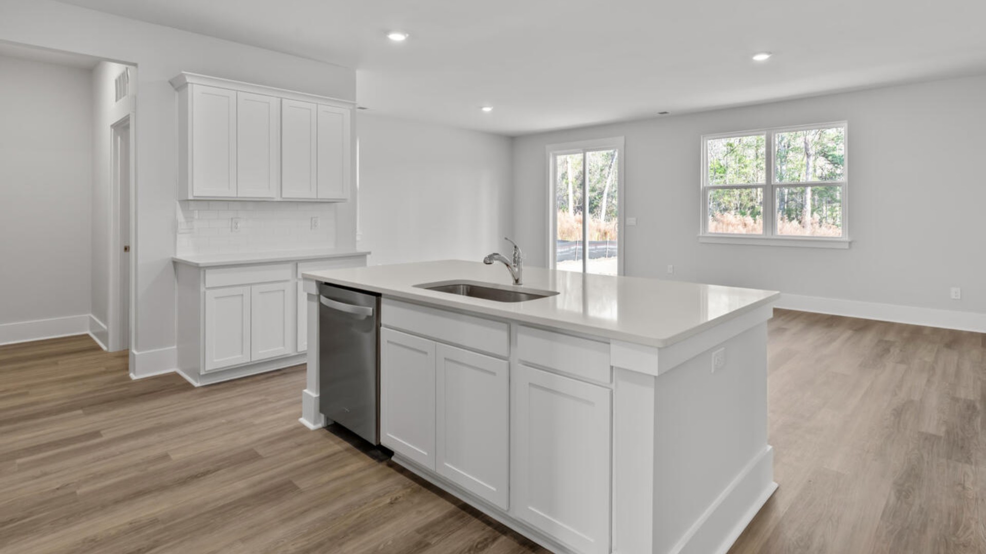 The kitchen features shaker-style cabinets, granite countertops, and stainless steel appliances, which are sure to both turn heads and make meal prep easy. You’ll never be too far from the action with the living and dining area right there.