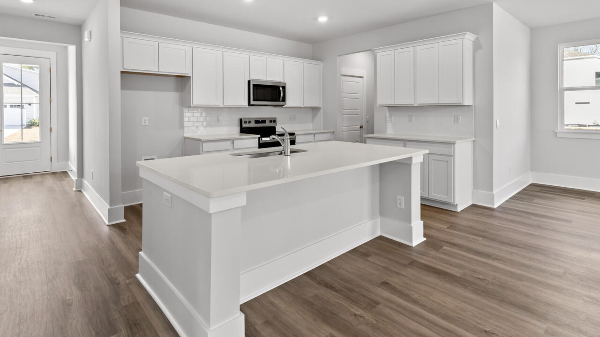 The kitchen features shaker-style cabinets, granite countertops, and stainless steel appliances, which are sure to both turn heads and make meal prep easy. You’ll never be too far from the action with the living and dining area right there.