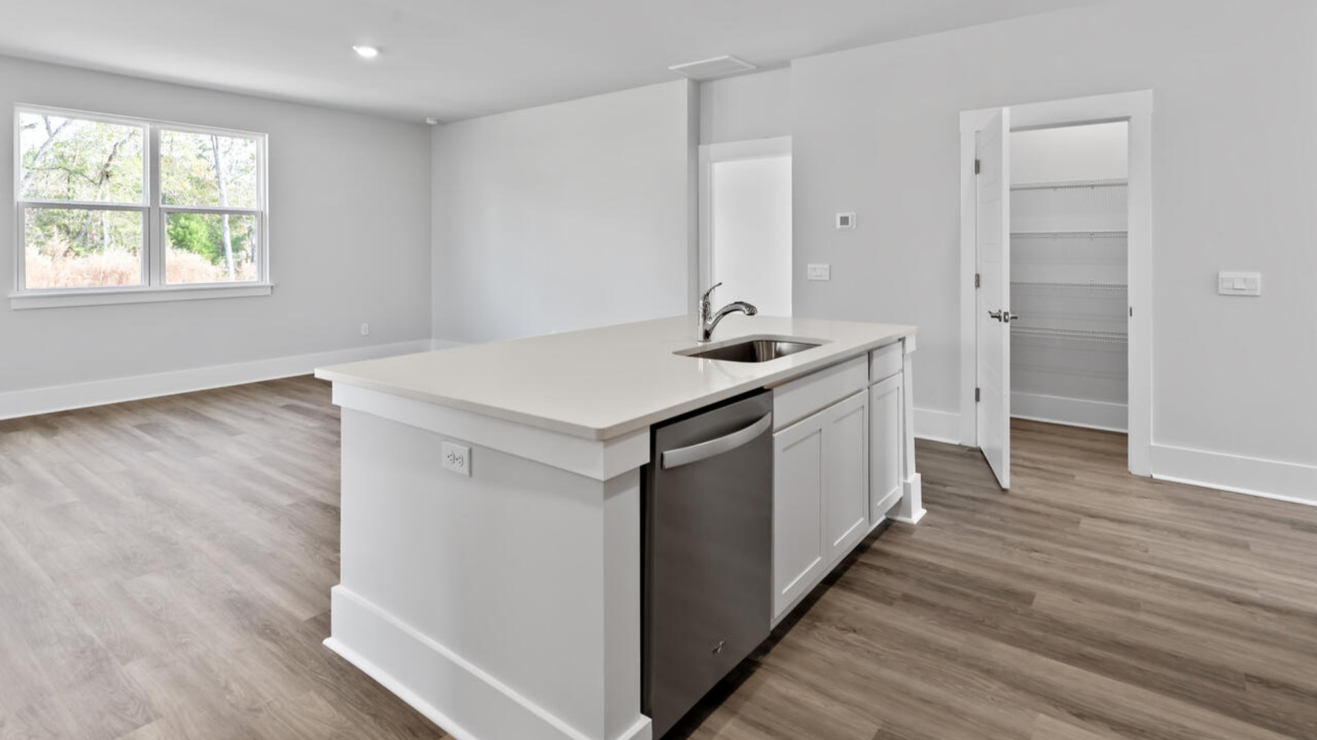 The kitchen features shaker-style cabinets, granite countertops, and stainless steel appliances, which are sure to both turn heads and make meal prep easy. You’ll never be too far from the action with the living and dining area right there.