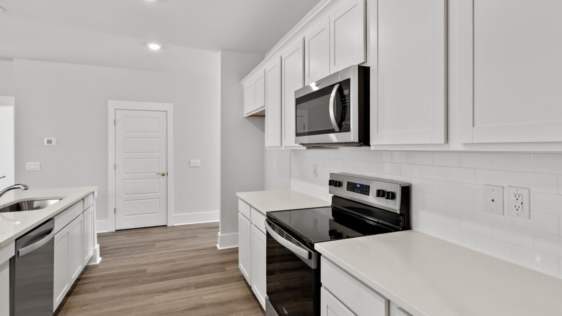 The kitchen features shaker-style cabinets, granite countertops, and stainless steel appliances, which are sure to both turn heads and make meal prep easy. You’ll never be too far from the action with the living and dining area right there.