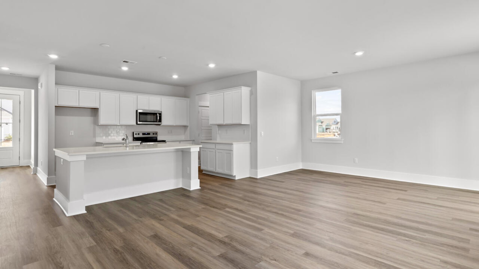 This home features a first floor primary bedroom suite and laundry room. The open concept kitchen and great room are ideal for entertaining and creating lasting memories.