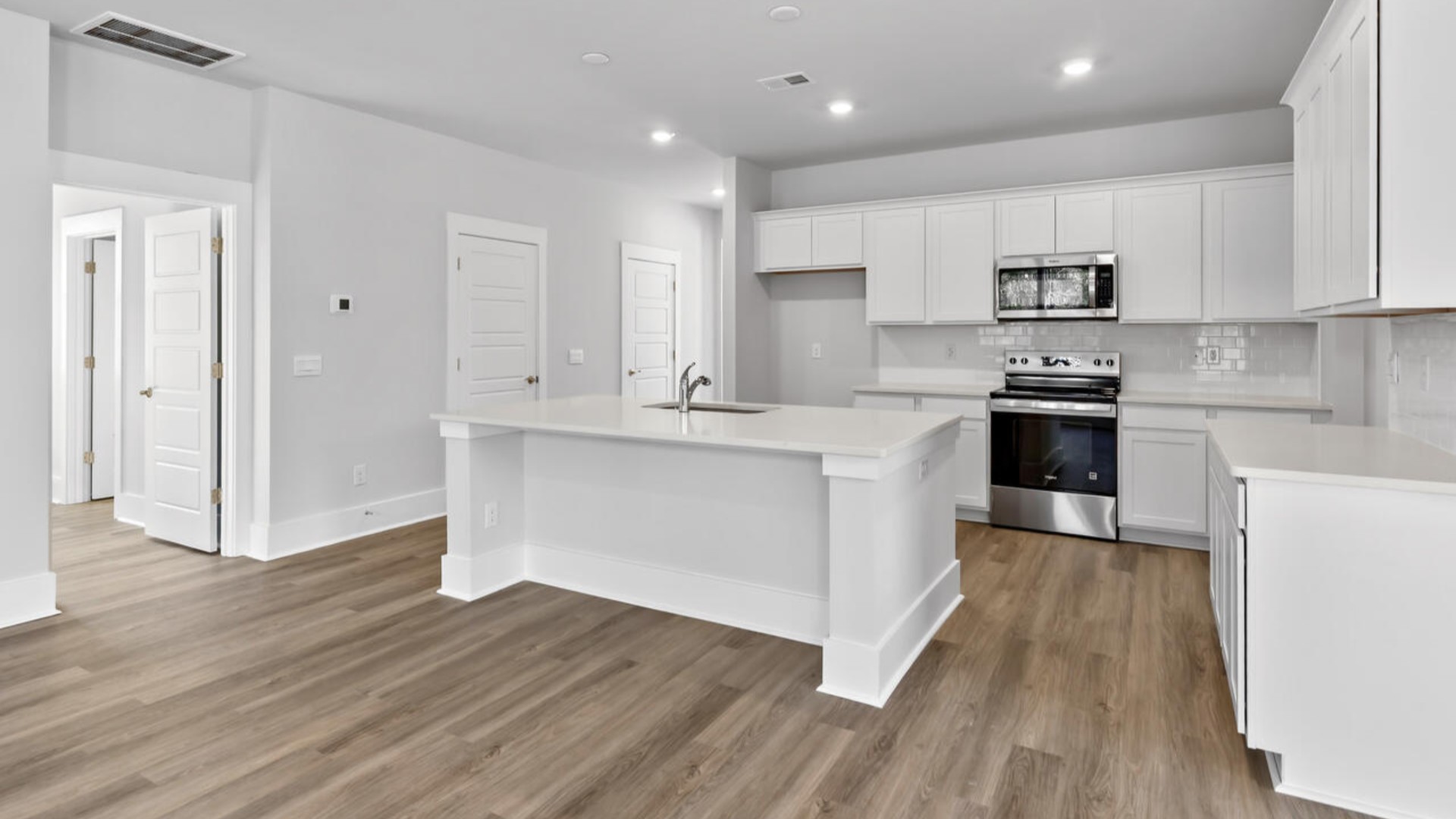 The kitchen features shaker-style cabinets, granite countertops, and stainless-steel appliances, which are sure to both turn heads and make meal prep easy. You’ll never be too far from the action with the living and dining area right there.