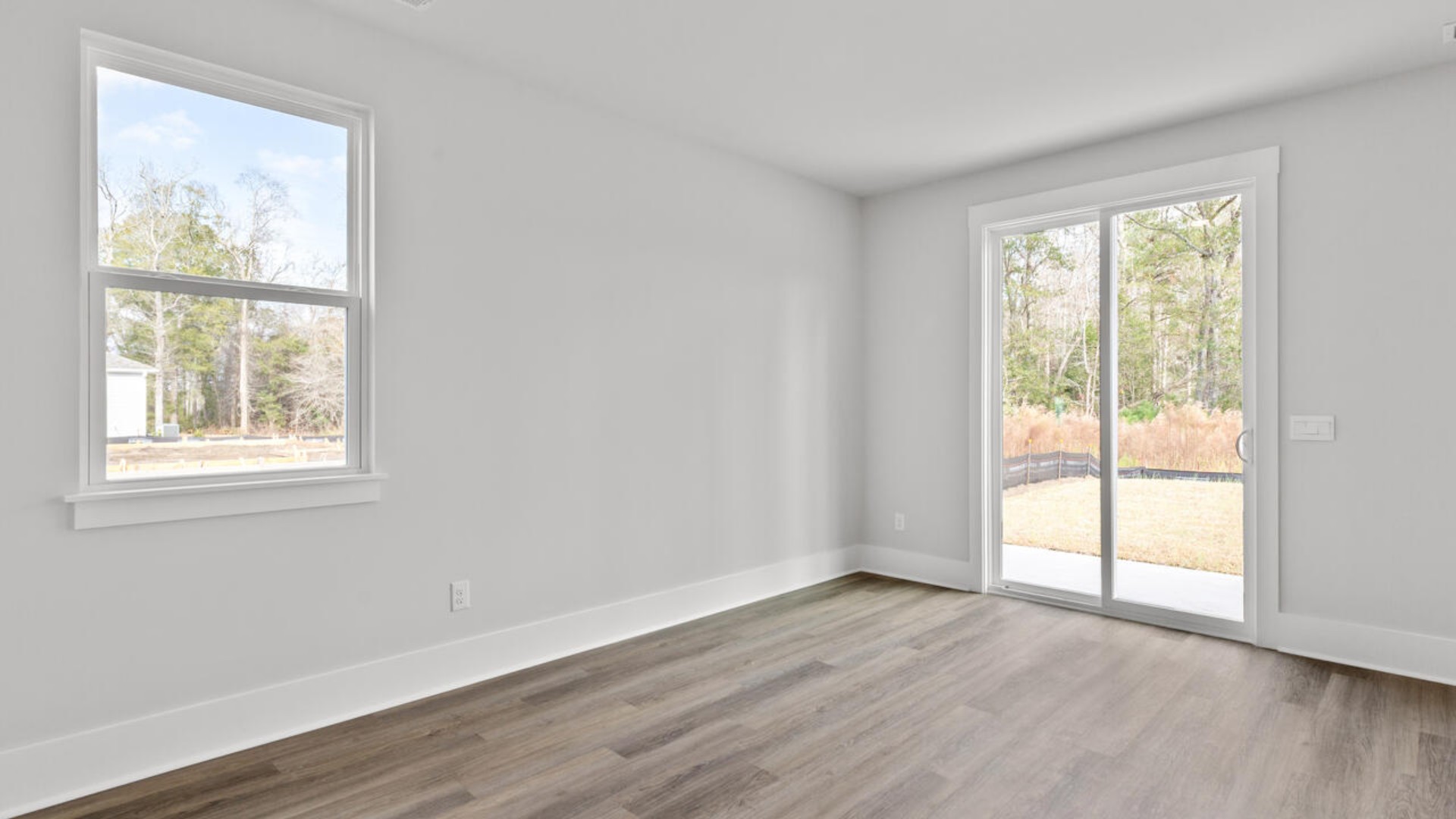 This home features a first-floor primary bedroom suite and laundry room. The open concept kitchen and great room are ideal for entertaining and creating lasting memories.
