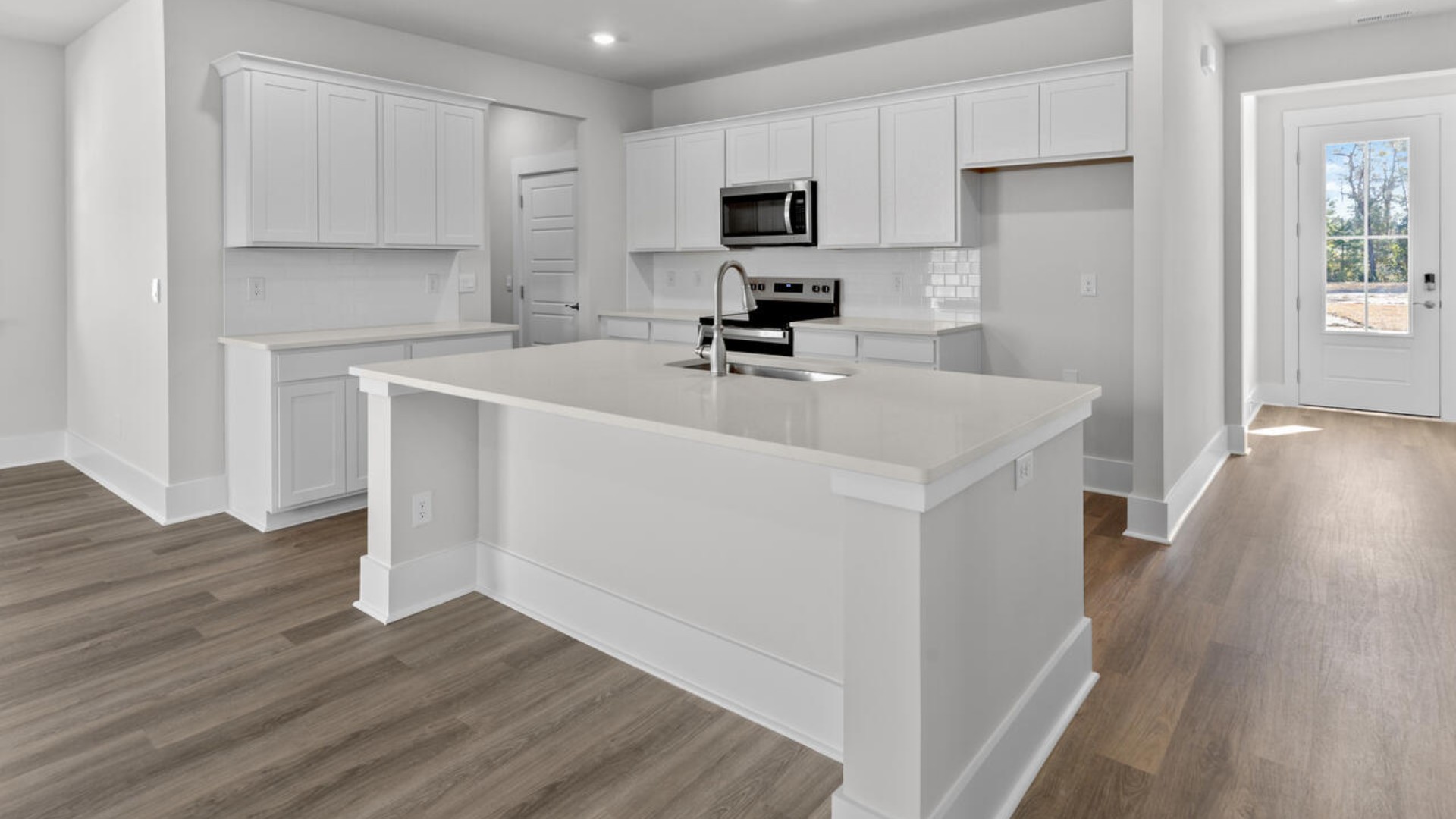The kitchen features shaker-style cabinets, granite countertops, and stainless steel appliances, which are sure to both turn heads and make meal prep easy. You’ll never be too far from the action with the living and dining area right there.