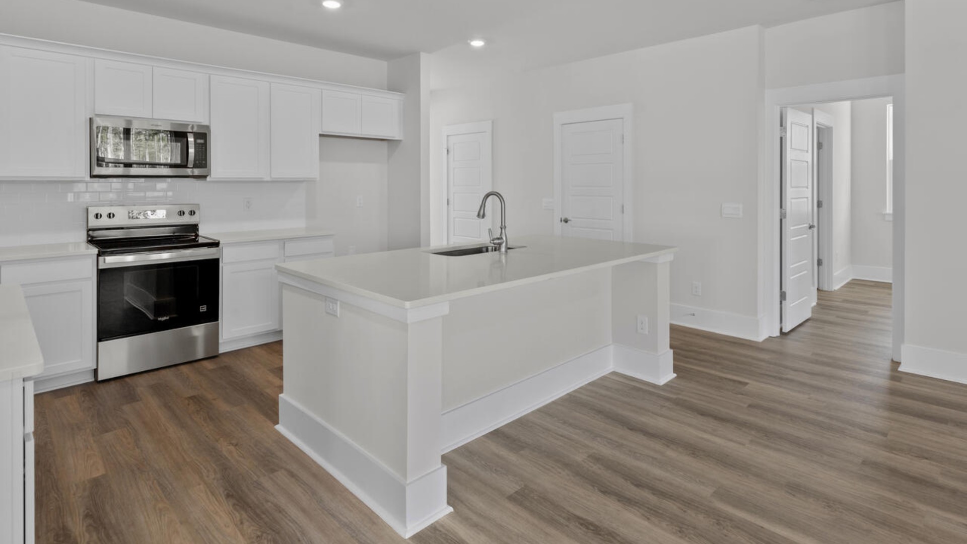The kitchen features shaker-style cabinets, granite countertops, and stainless steel appliances, which are sure to both turn heads and make meal prep easy. You’ll never be too far from the action with the living and dining area right there.