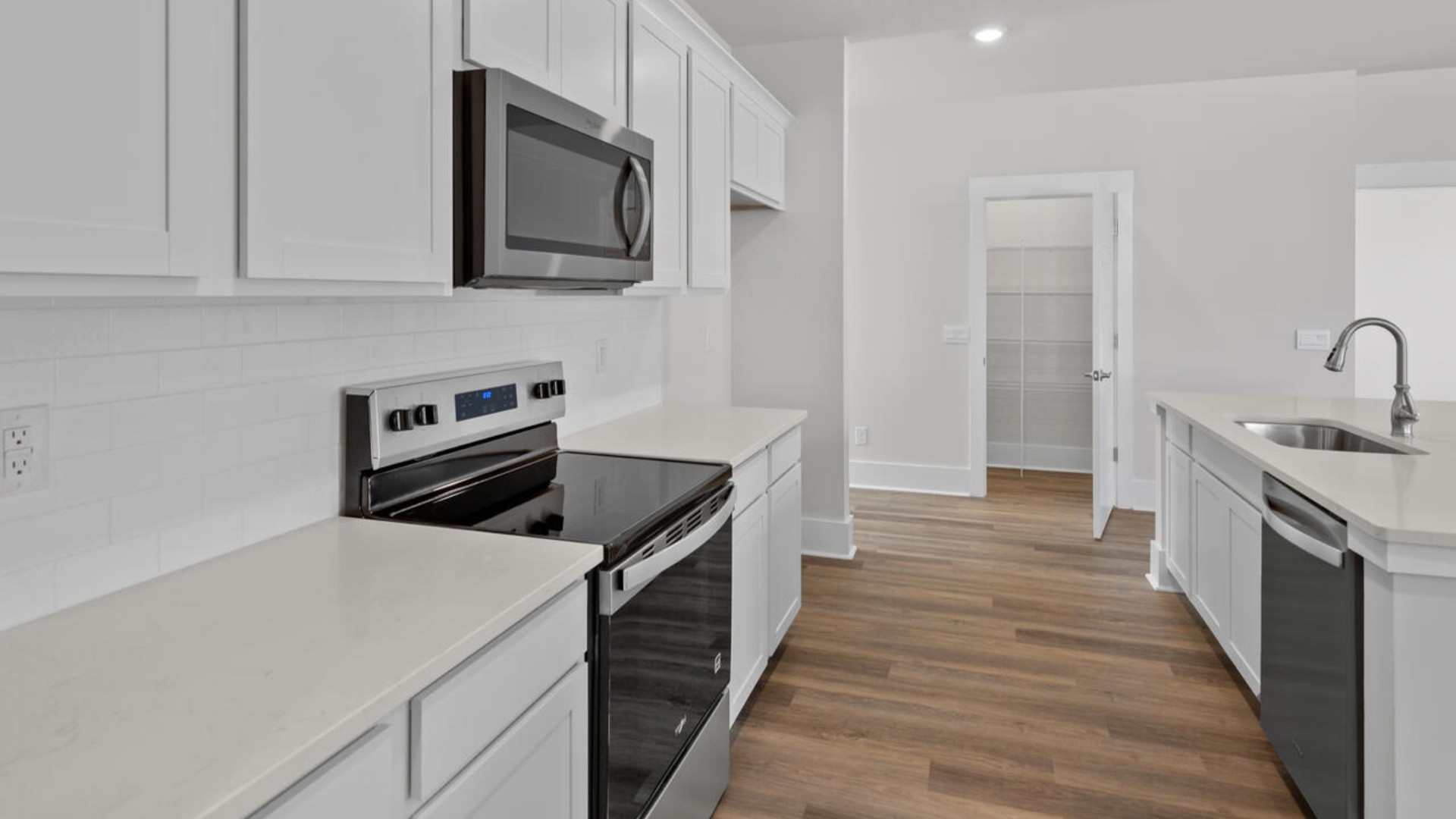 The kitchen features shaker-style cabinets, granite countertops, and stainless steel appliances, which are sure to both turn heads and make meal prep easy. You’ll never be too far from the action with the living and dining area right there.