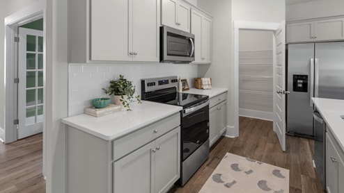 This home boasts granite kitchen counter tops, walk-in pantry, ample storage space a large kitchen island that overlooks the dining area and patio, as well as a 45-degree angle pantry for ample food storage
