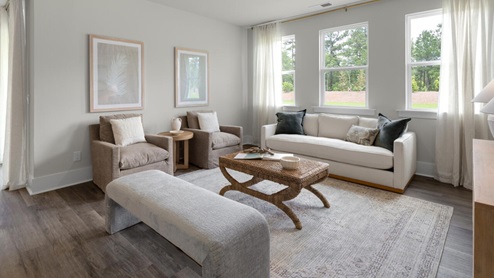 The primary suite as well as on suite is sure to impress with double vanities and a massive walk-in closet., a large, covered porch for those nice breezy sunsets! LVP floors are installed throughout the home as well as the stain resistant carpets that add comfort to the bedrooms.