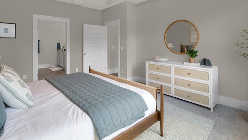 The primary suite as well as on suite is sure to impress with double vanities and a massive walk-in closet., a large, covered porch for those nice breezy sunsets! LVP floors are installed throughout the home as well as the stain resistant carpets that add comfort to the bedrooms.