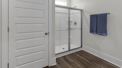 The primary suite as well as on suite is sure to impress with double vanities and a massive walk-in closet., a large, covered porch for those nice breezy sunsets! LVP floors are installed throughout the home as well as the stain resistant carpets that add comfort to the bedrooms.