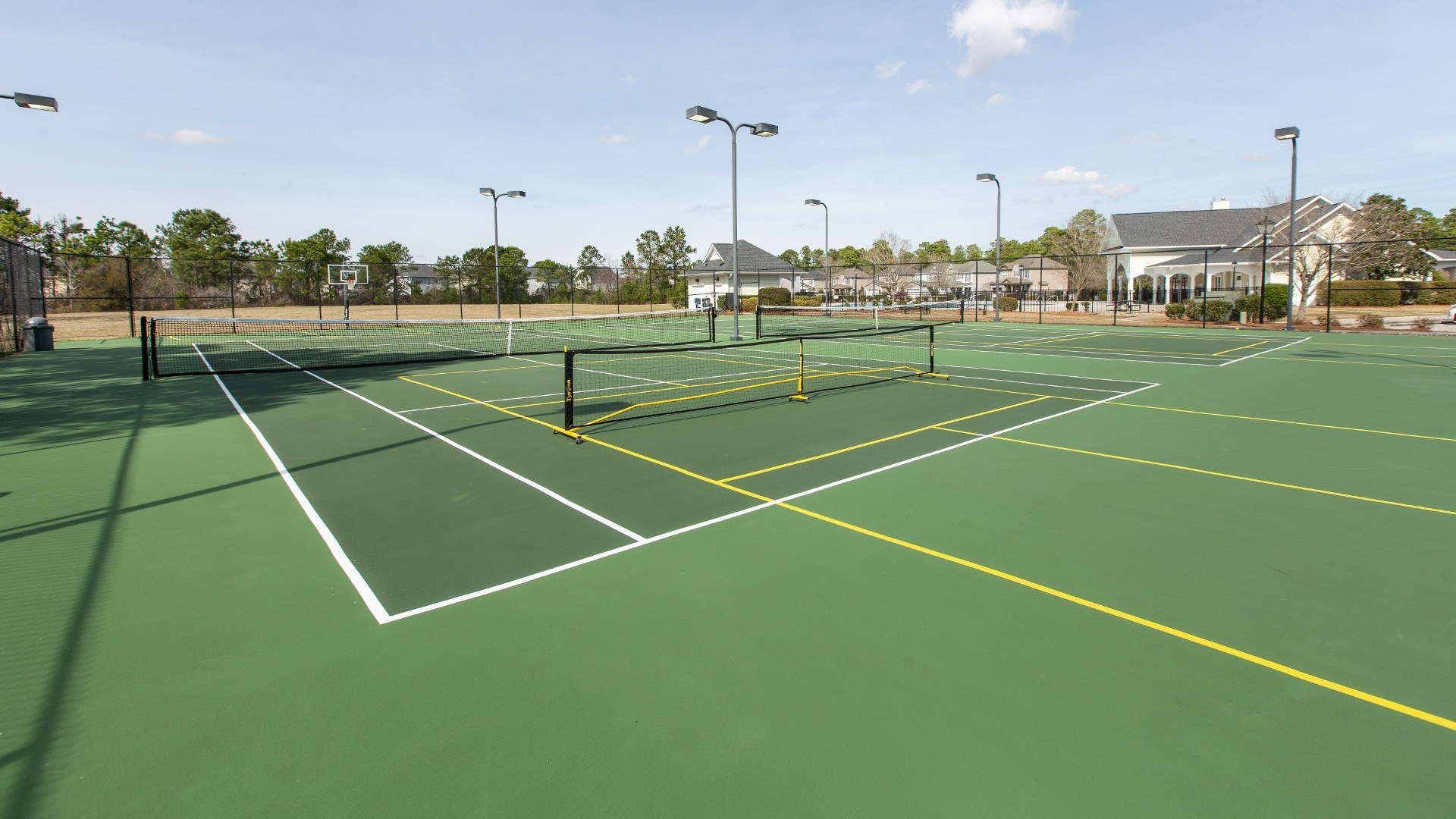 Homeowners have access to a range of amenities such as a well-equipped clubhouse, a fitness room, a spacious competition swimming pool, a kiddie pool, a hot tub, a sports court, a playground, and picturesque nature trails for walking.