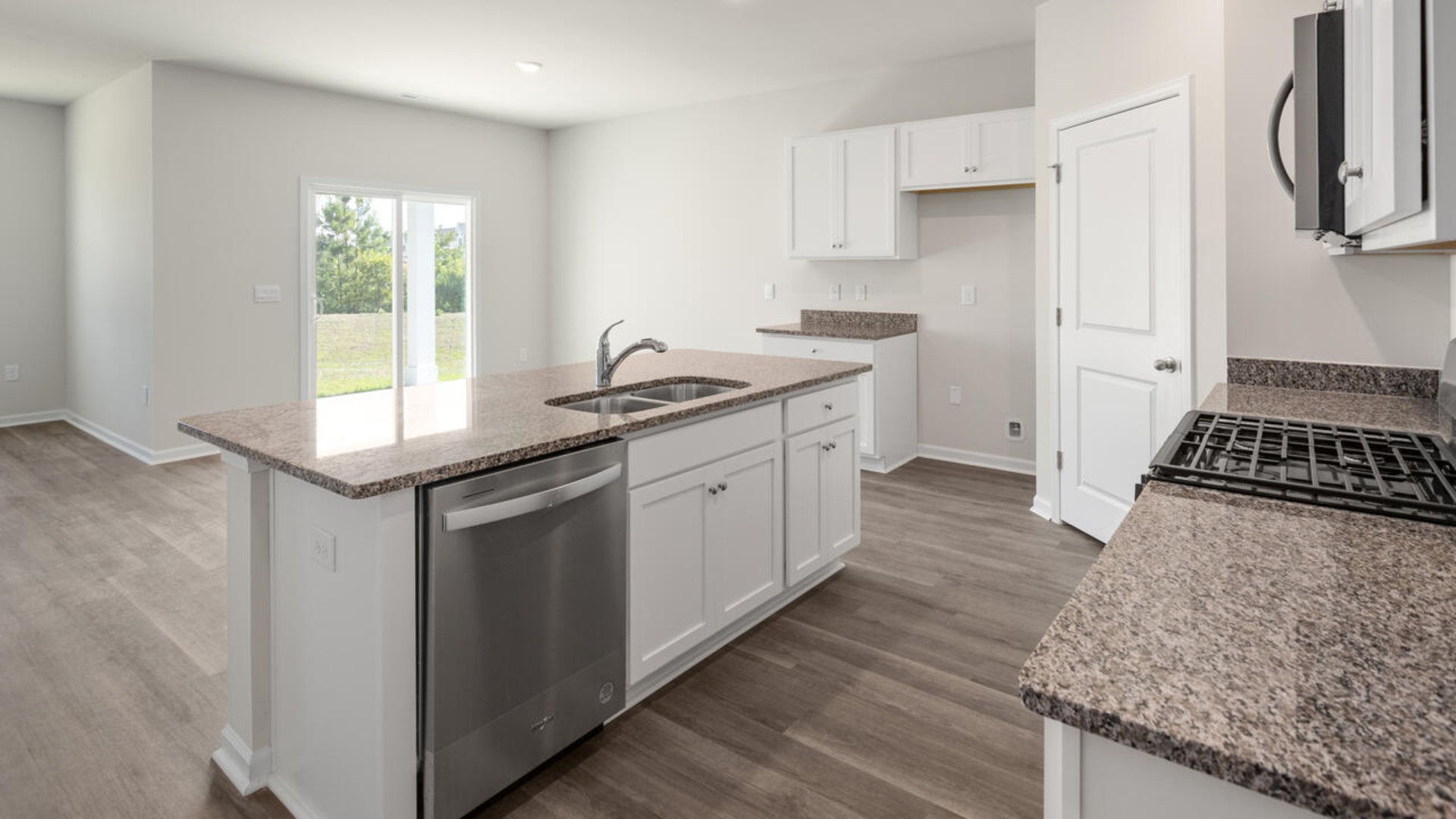 The kitchen features beautiful cabinets, granite countertops, and stainless steel appliances, which are sure to both turn heads and make meal prep easy.