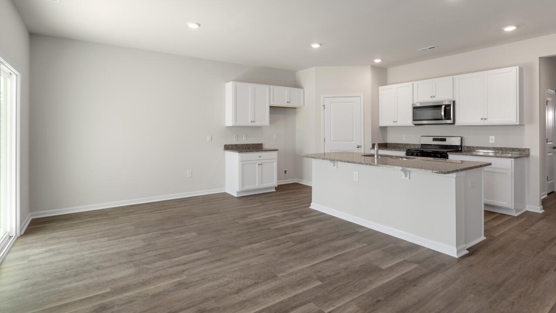 The kitchen features beautiful cabinets, granite countertops, and stainless steel appliances, which are sure to both turn heads and make meal prep easy.