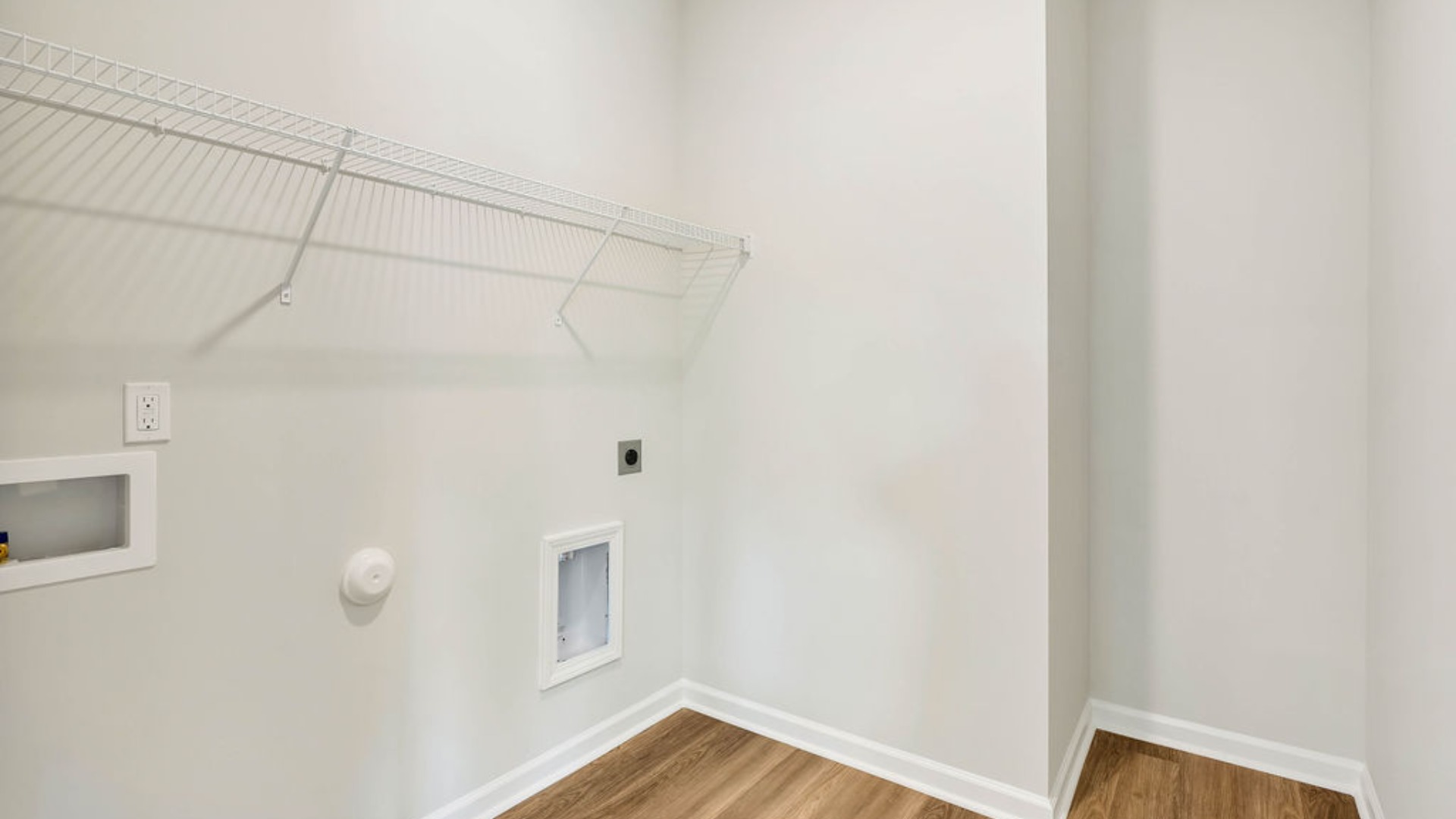 There is a bedroom at the front of the home and two additional main-floor bedrooms, and a shared full bathroom sit near the front of the home.