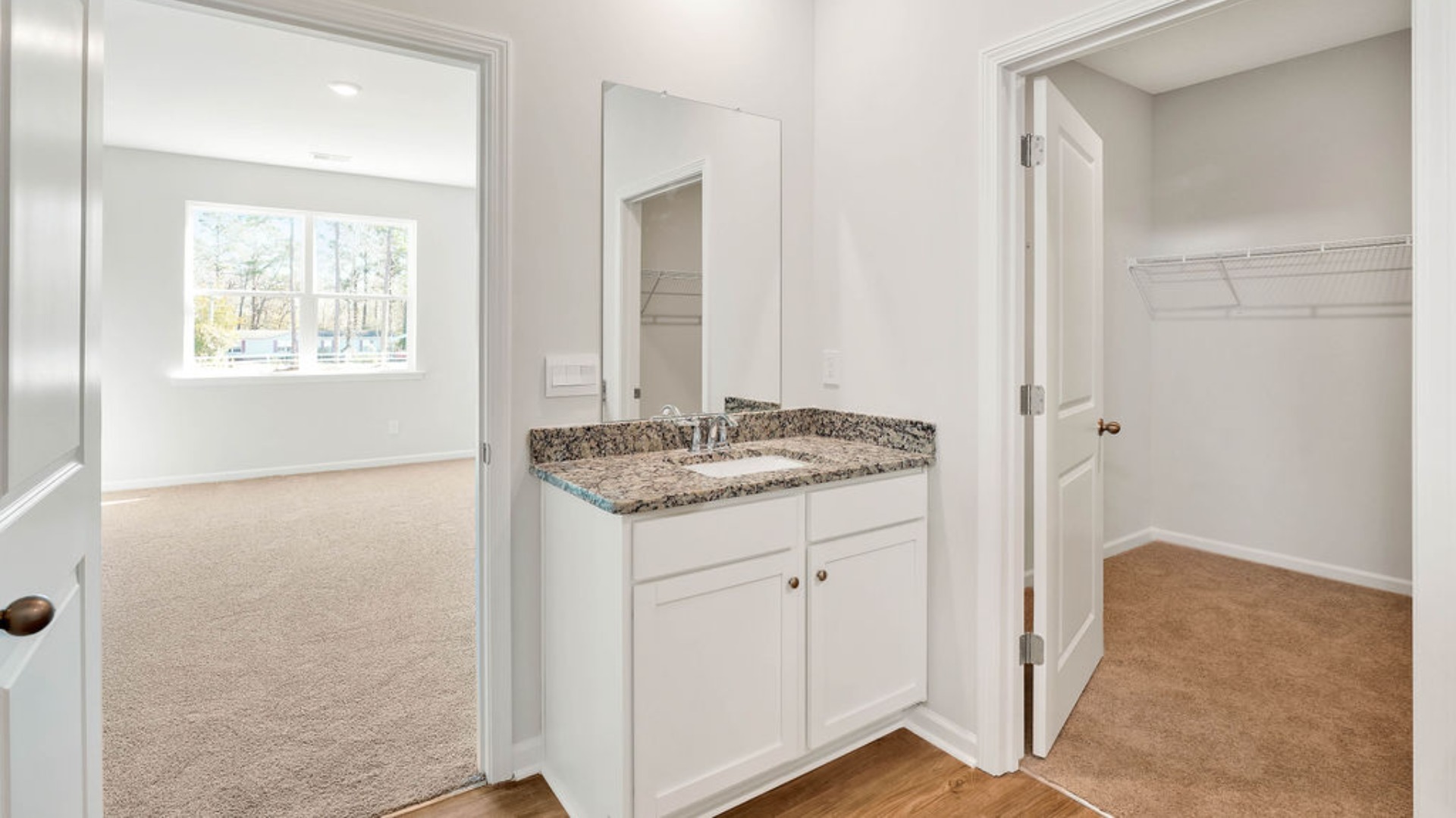 Situated entirely at the rear of the home for optimal isolation, complete with dual vanities, a large walk-in shower, and a walk-in closet.