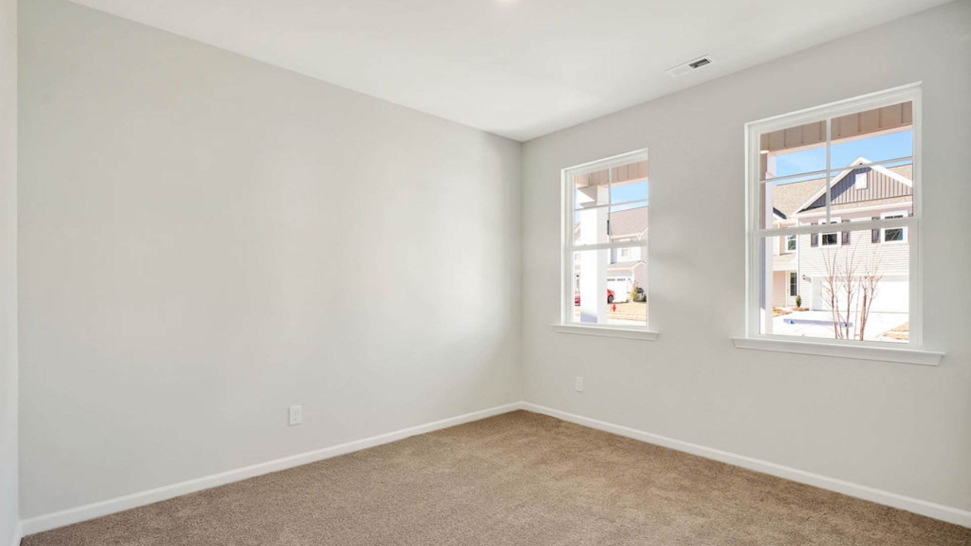 There is a bedroom at the front of the home and two additional main-floor bedrooms, and a shared full bathroom sit near the front of the home.