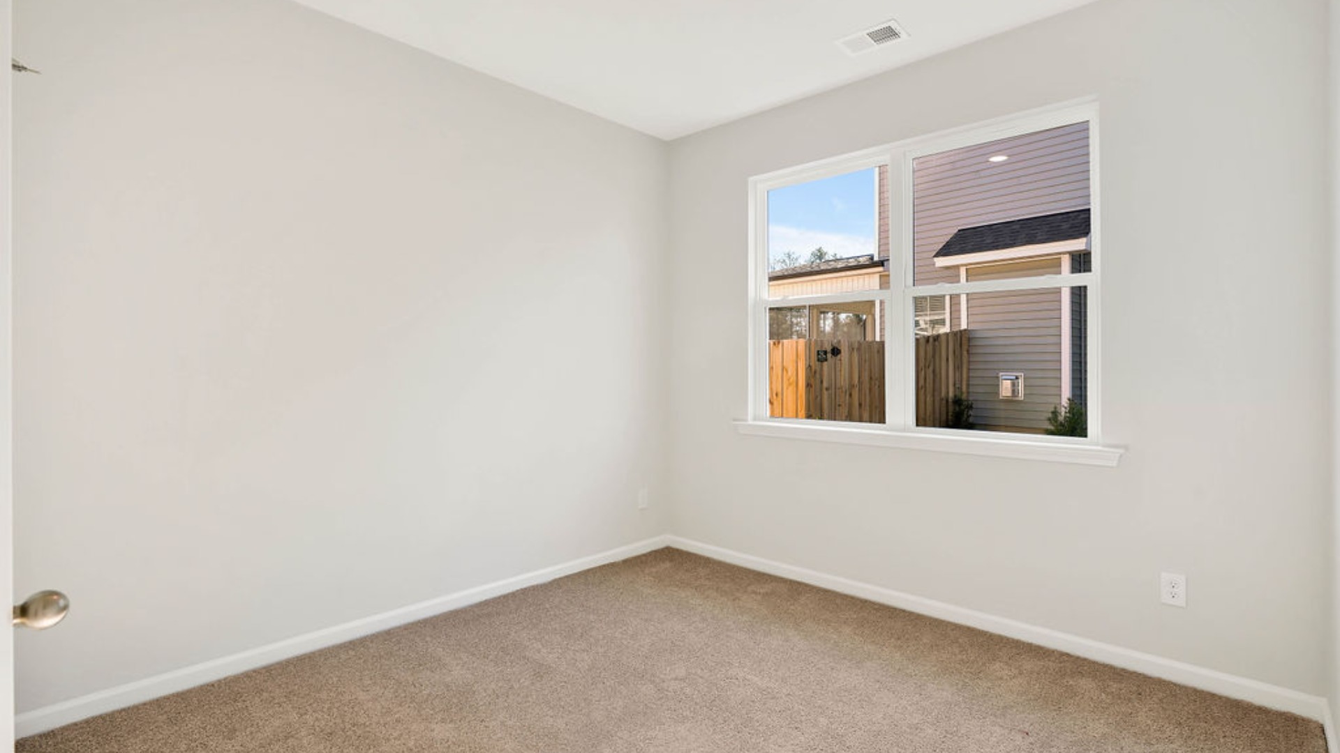 There is a bedroom at the front of the home and two additional main-floor bedrooms, and a shared full bathroom sit near the front of the home.